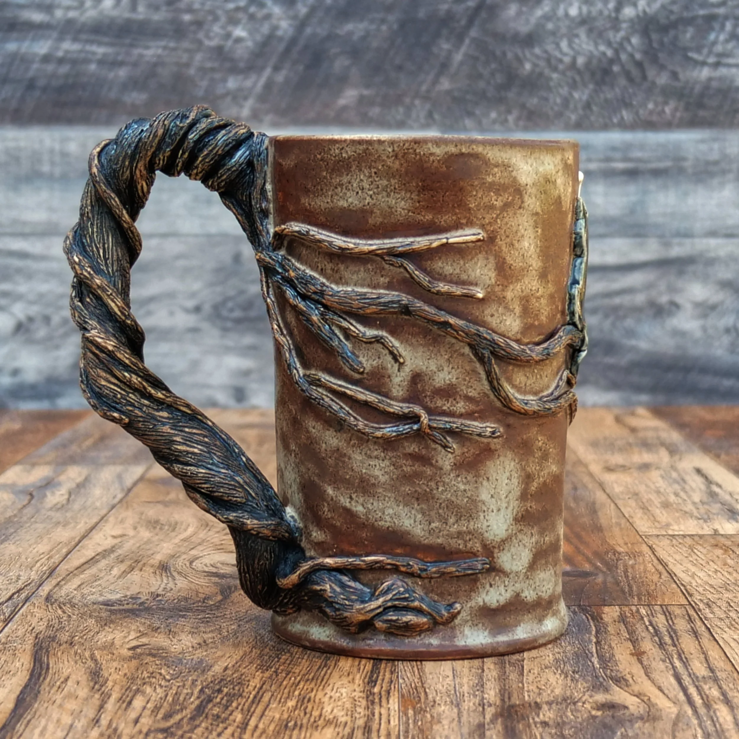 Handmade Moonwatcher Mug by Elderkiln Ceramics featuring a sculpted cat sitting on a tree branch beneath the moon, with wraparound woodland details and a twisted branch handle.