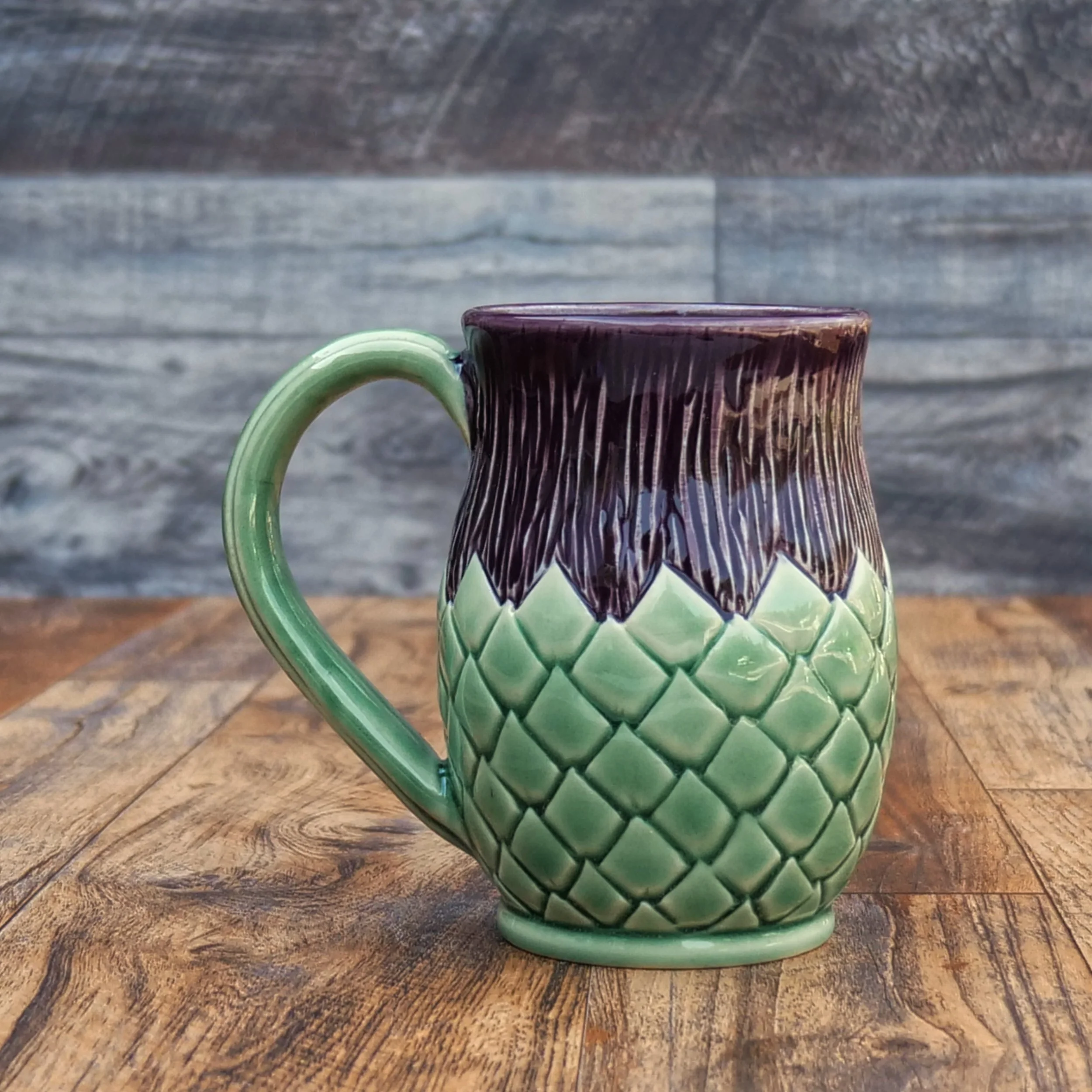 Handmade Highland Thistle Mug by Elderkiln Ceramics featuring sculpted thistle-inspired textures and layered purple and green stoneware glazes.