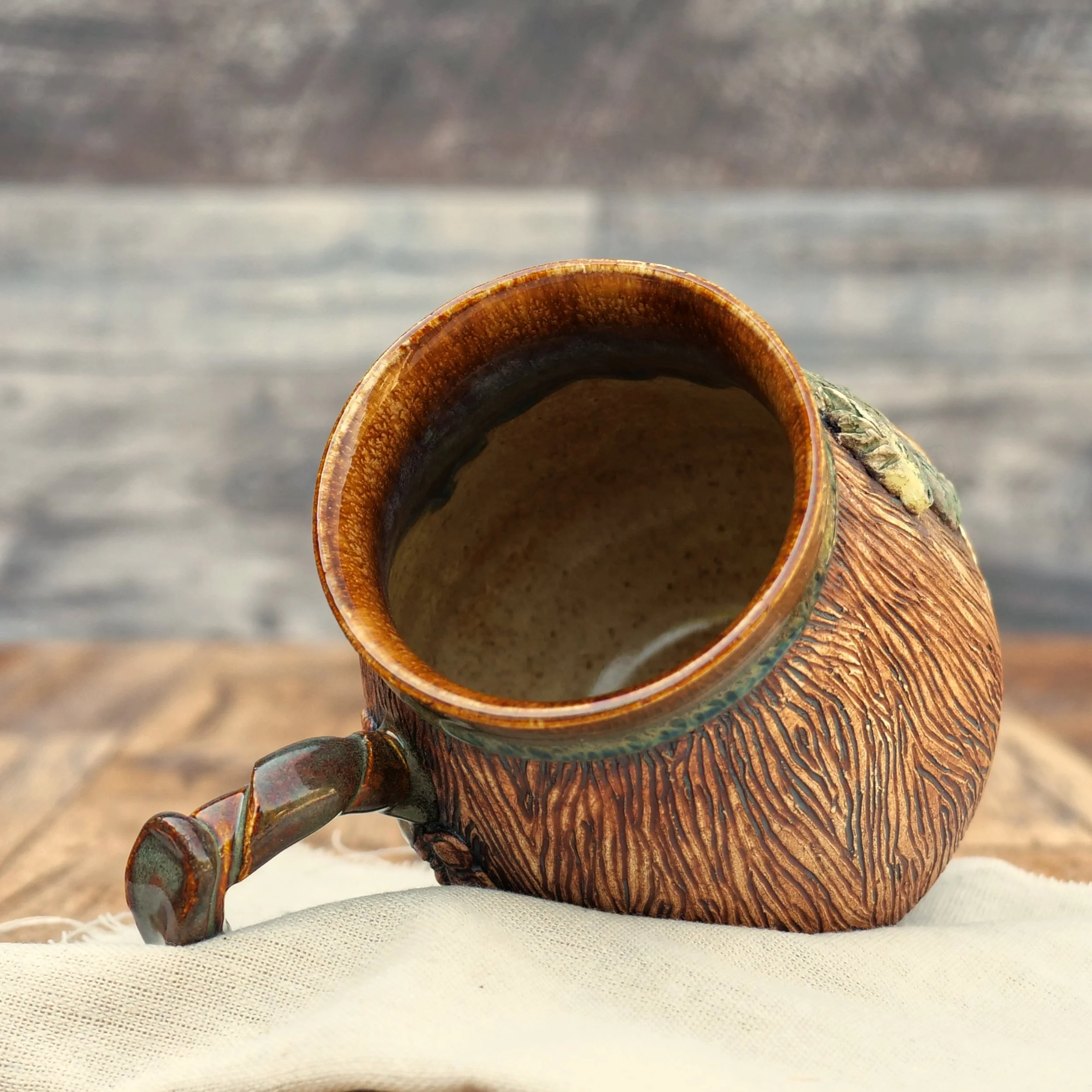 Handmade Woodland Dragon Mug by Elderkiln Ceramics featuring a sculpted forest dragon, carved woodgrain texture, branch-style handle, and earthy woodland glazes.