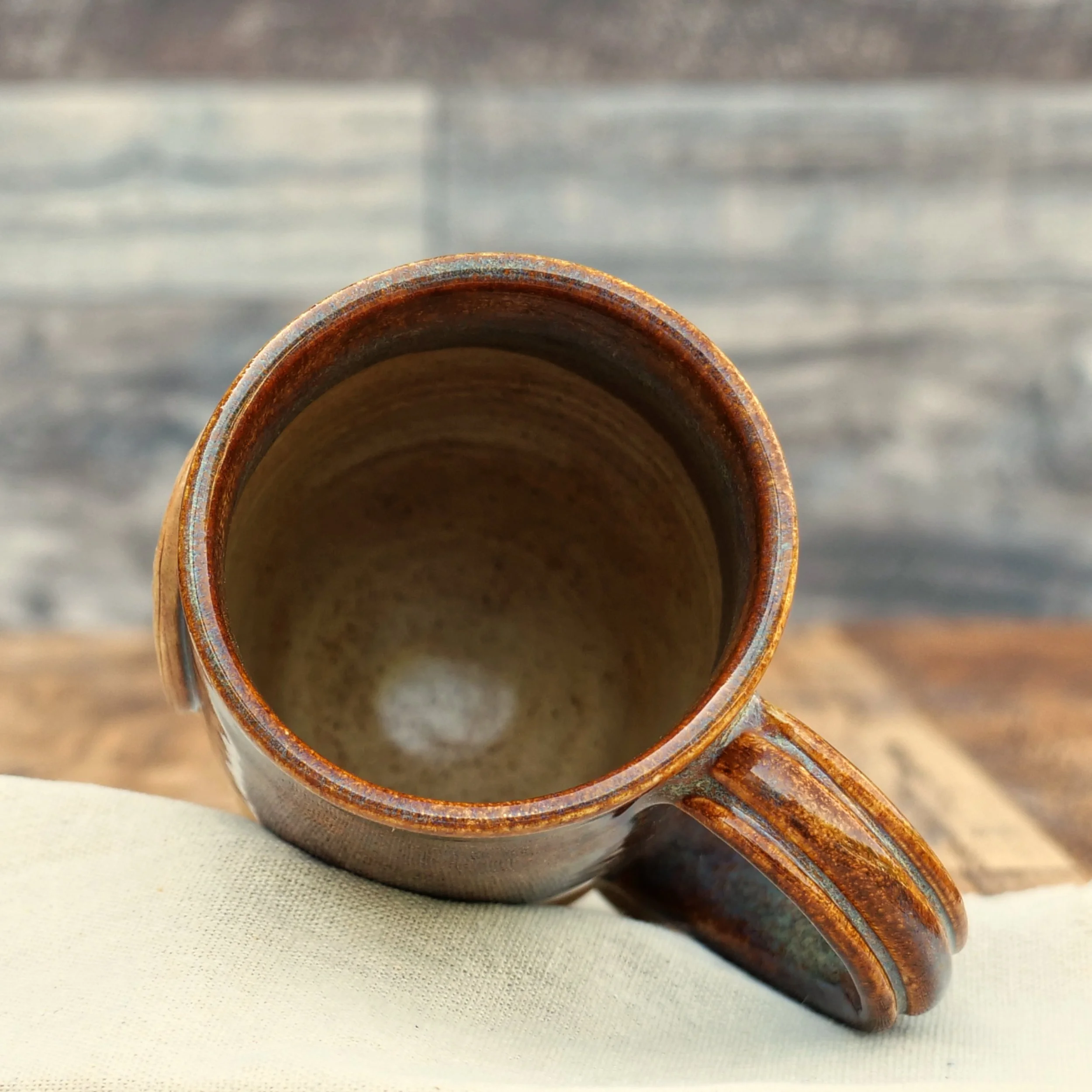 Handmade Tree of Life Mug by Elderkiln Ceramics featuring a sculpted Tree of Life medallion, Celtic-inspired details, and layered earthy stoneware glazes.