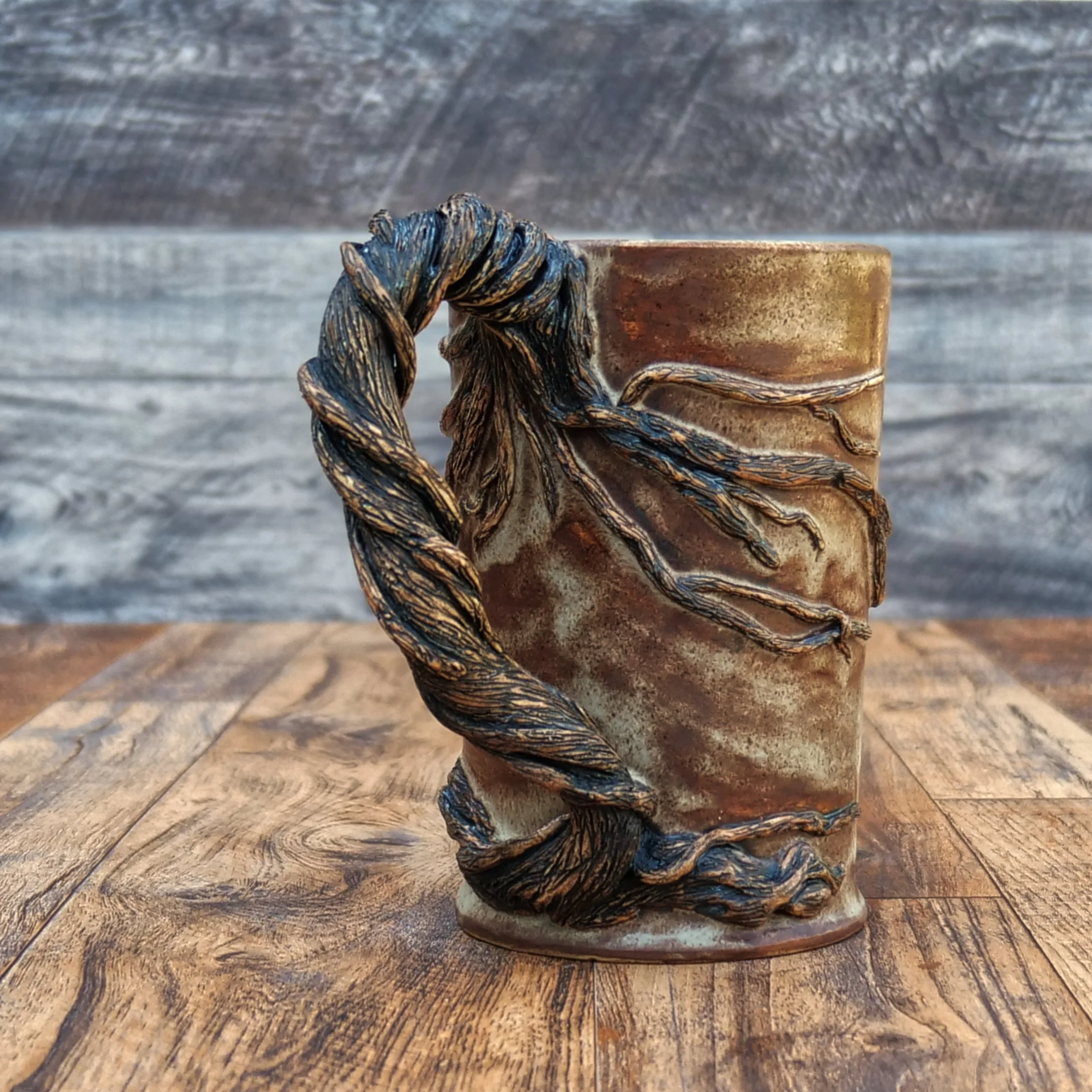 Handmade Moonwatcher Mug by Elderkiln Ceramics featuring a sculpted cat sitting on a tree branch beneath the moon, with wraparound woodland details and a twisted branch handle.