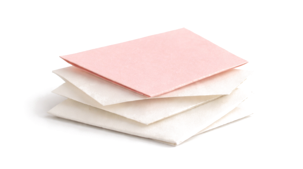 Stack of three sheets of paper, pink on top and white below