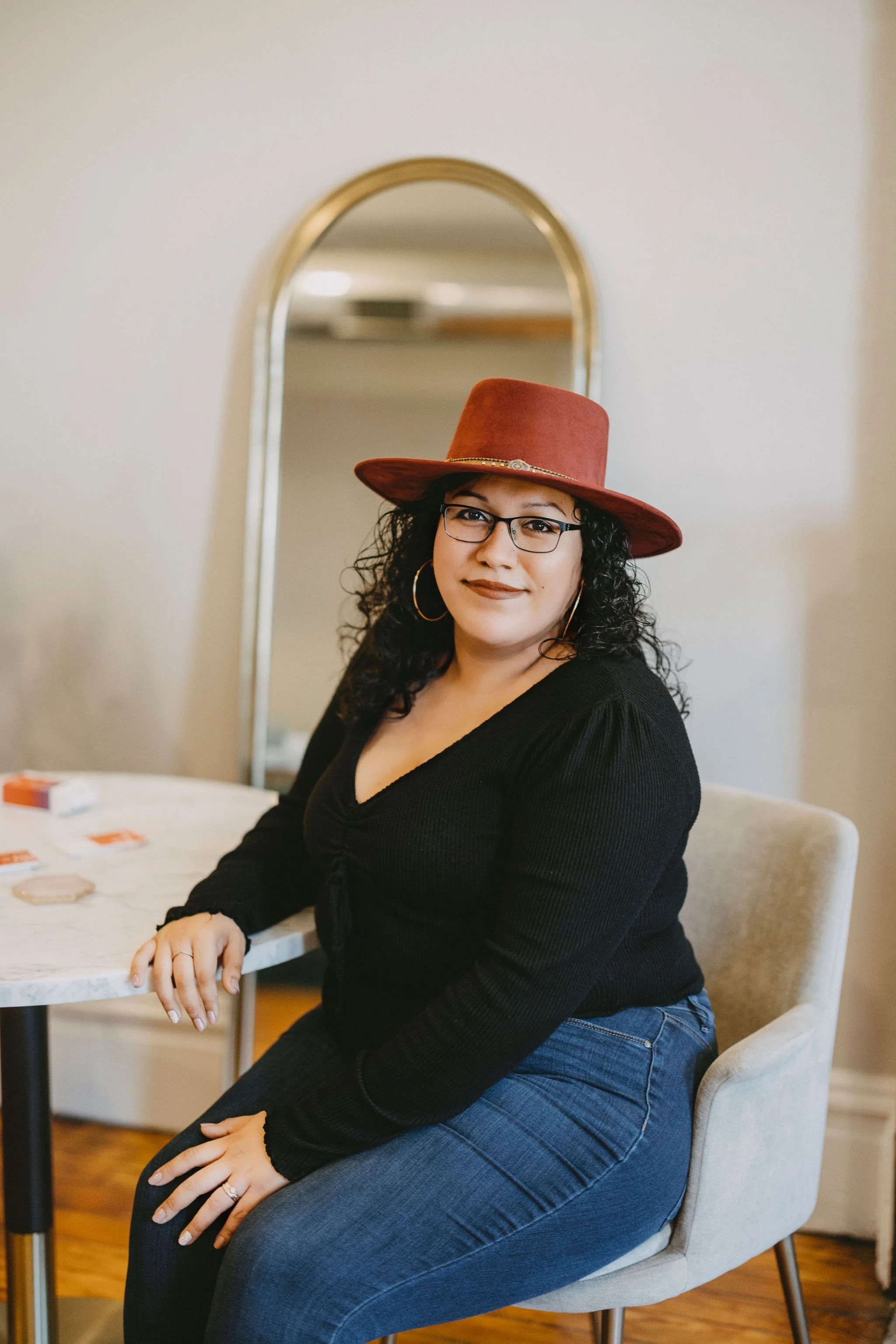 Latina Therapist sitting in  a chair