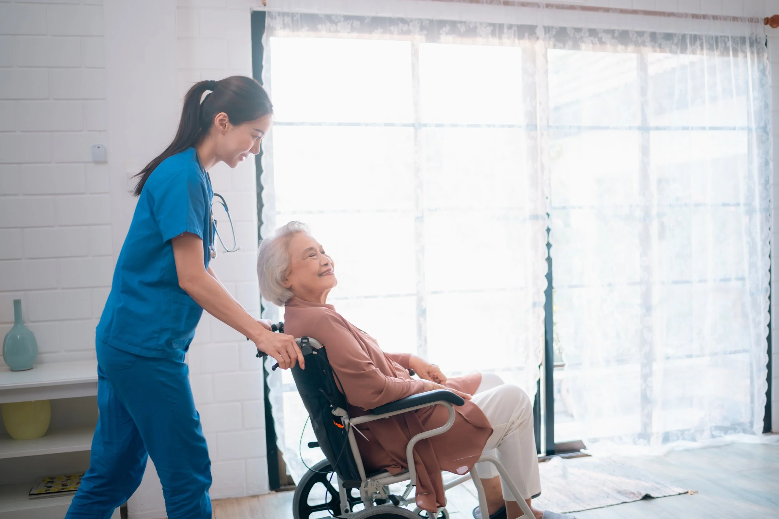 a caregiver caring for an elderly patient