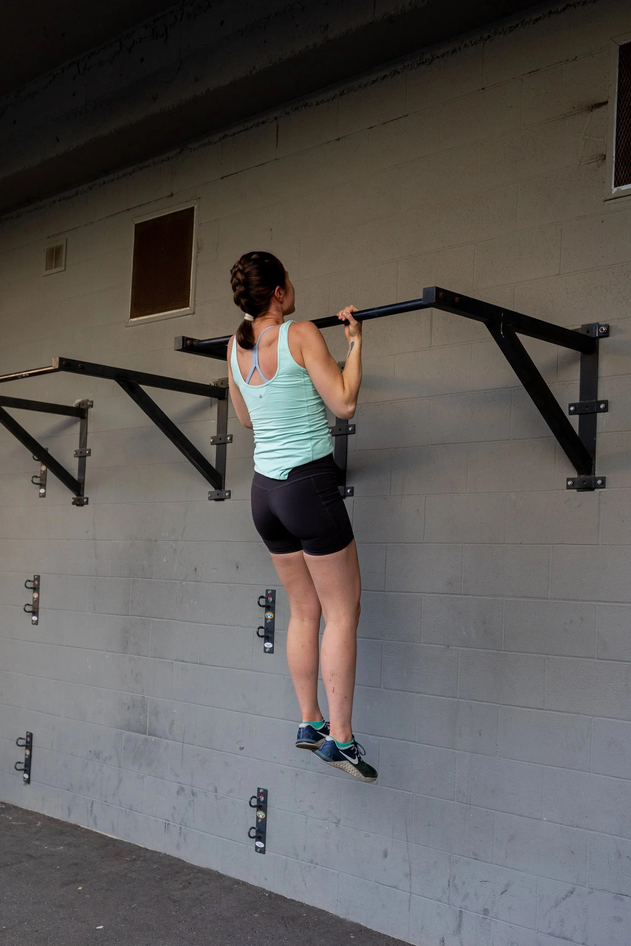 Online coaching client doing a pull-up to get stronger in Vancouver
