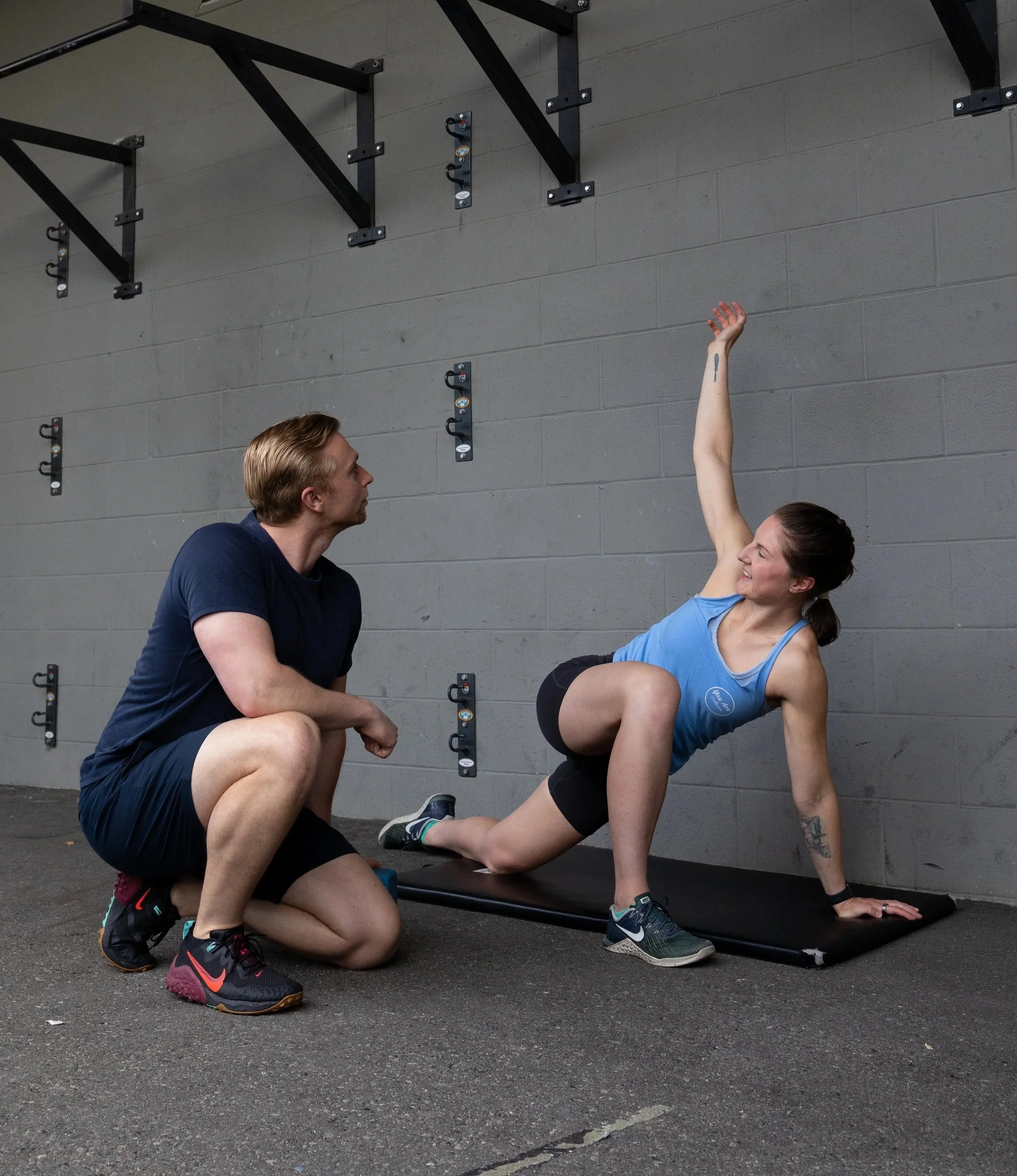 Personal trainer coaching a client through stretching to improve movement and reduce pain in Vancouver