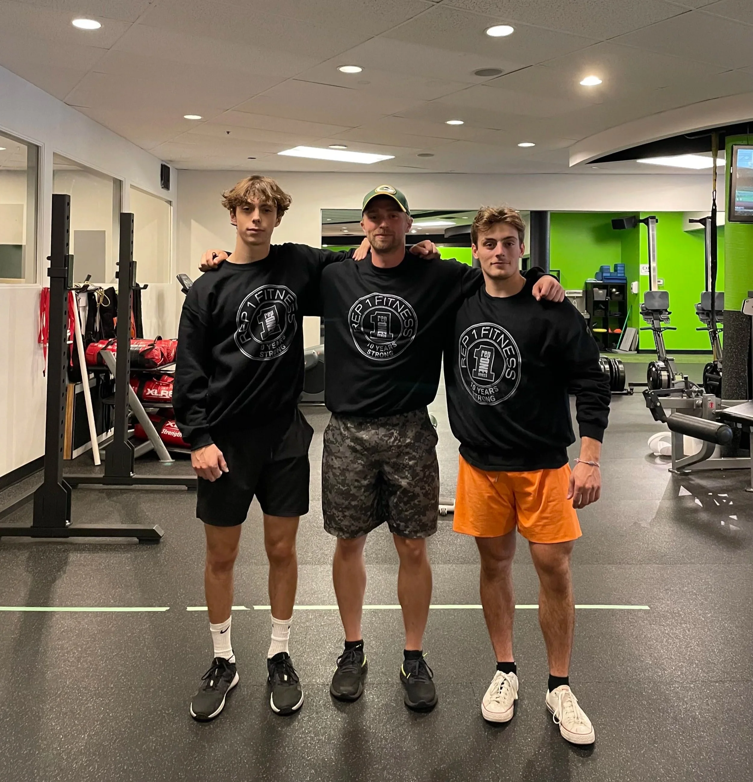 Personal trainer and two athlete personal training clients posing for a photo