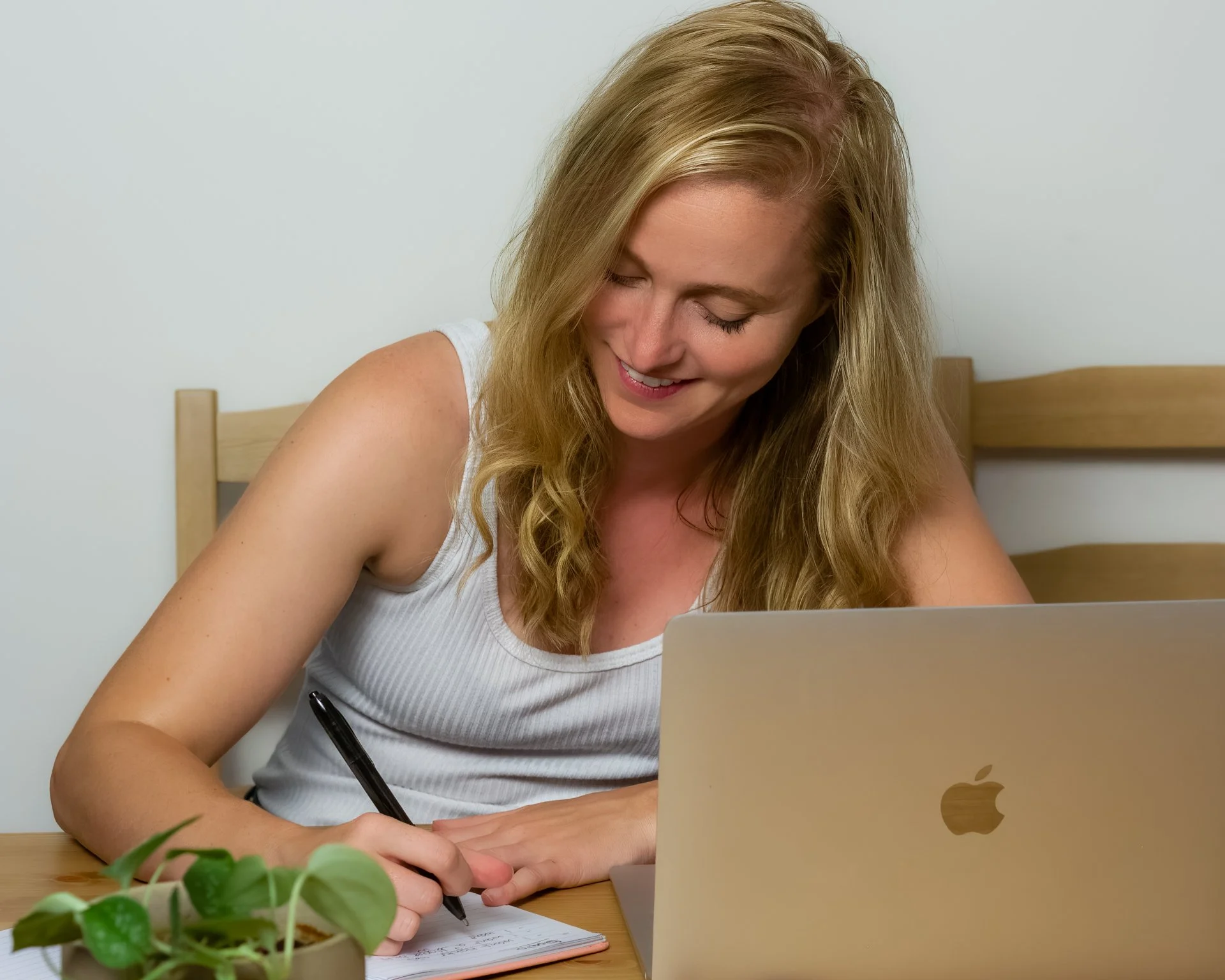 Custom program client taking workout notes to improve movement and get stronger in Vancouver