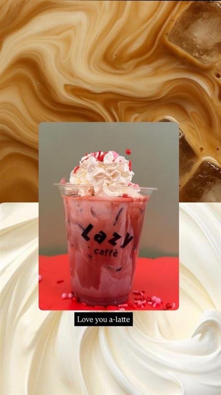 A pink and white iced drink with whipped cream and candy sprinkles in a clear plastic cup labeled "Lazy café."