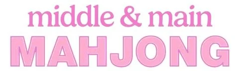 Text reading 'middle & main MAHJONG' in pink fonts on a white background.