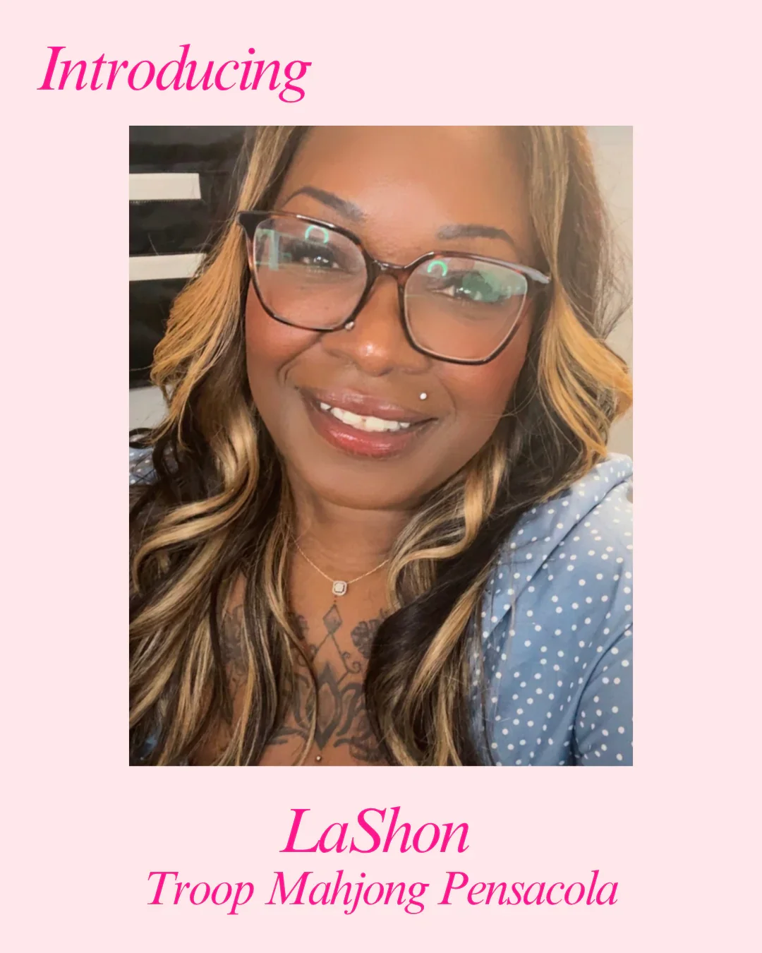 A smiling woman with glasses and blonde highlights, wearing a polka-dot top, displaying tattoos on her chest and a piercing on her lip. The background features a pink border with text introducing LaShon from Troop Mahjong Pensacola.