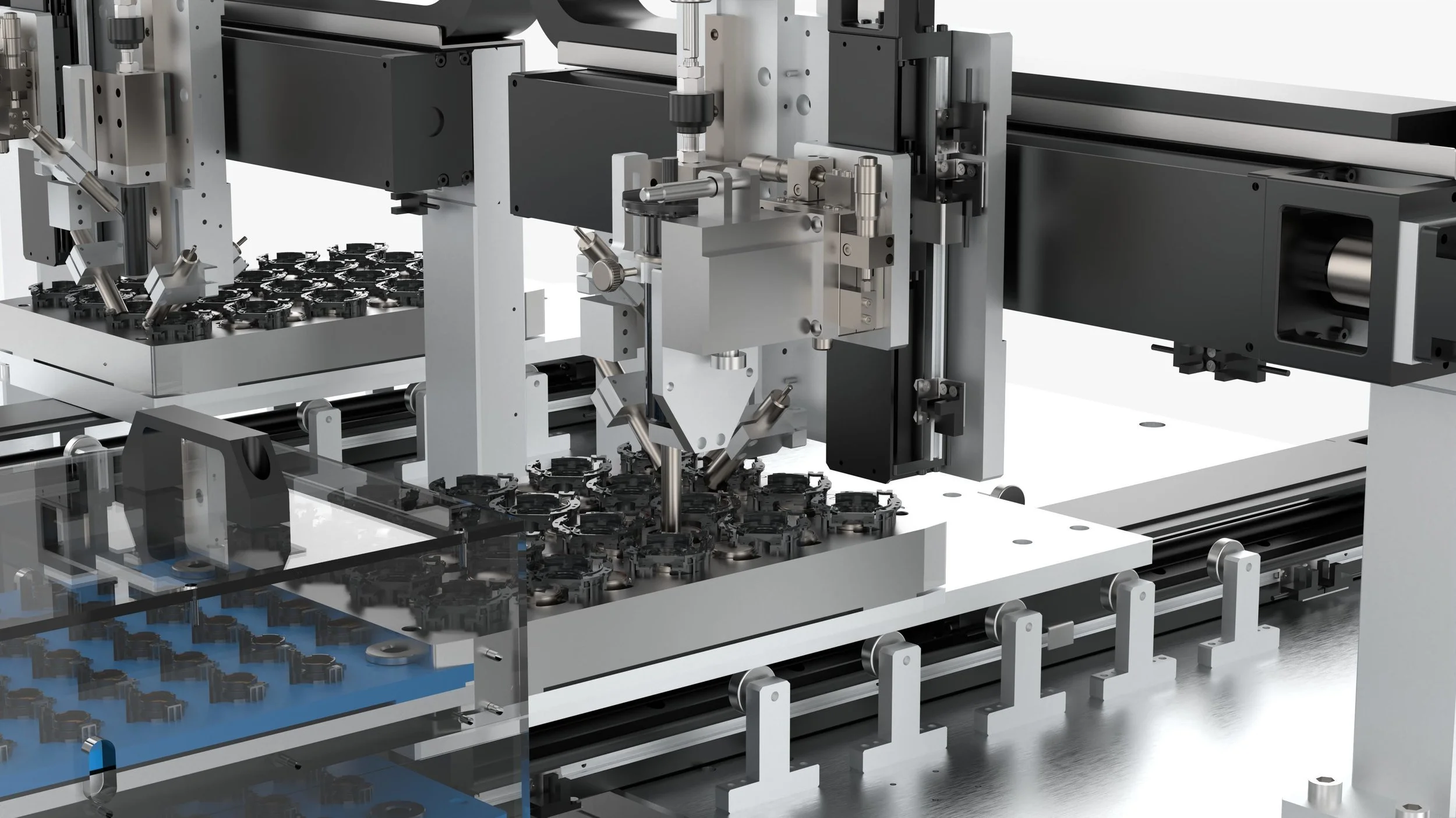 A detailed industrial machine used for manufacturing or assembly, with various mechanical parts, components, and a conveyor system.