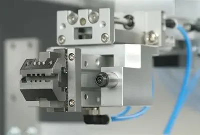 Close-up of a precision industrial mechanical component with metal parts and blue wires.