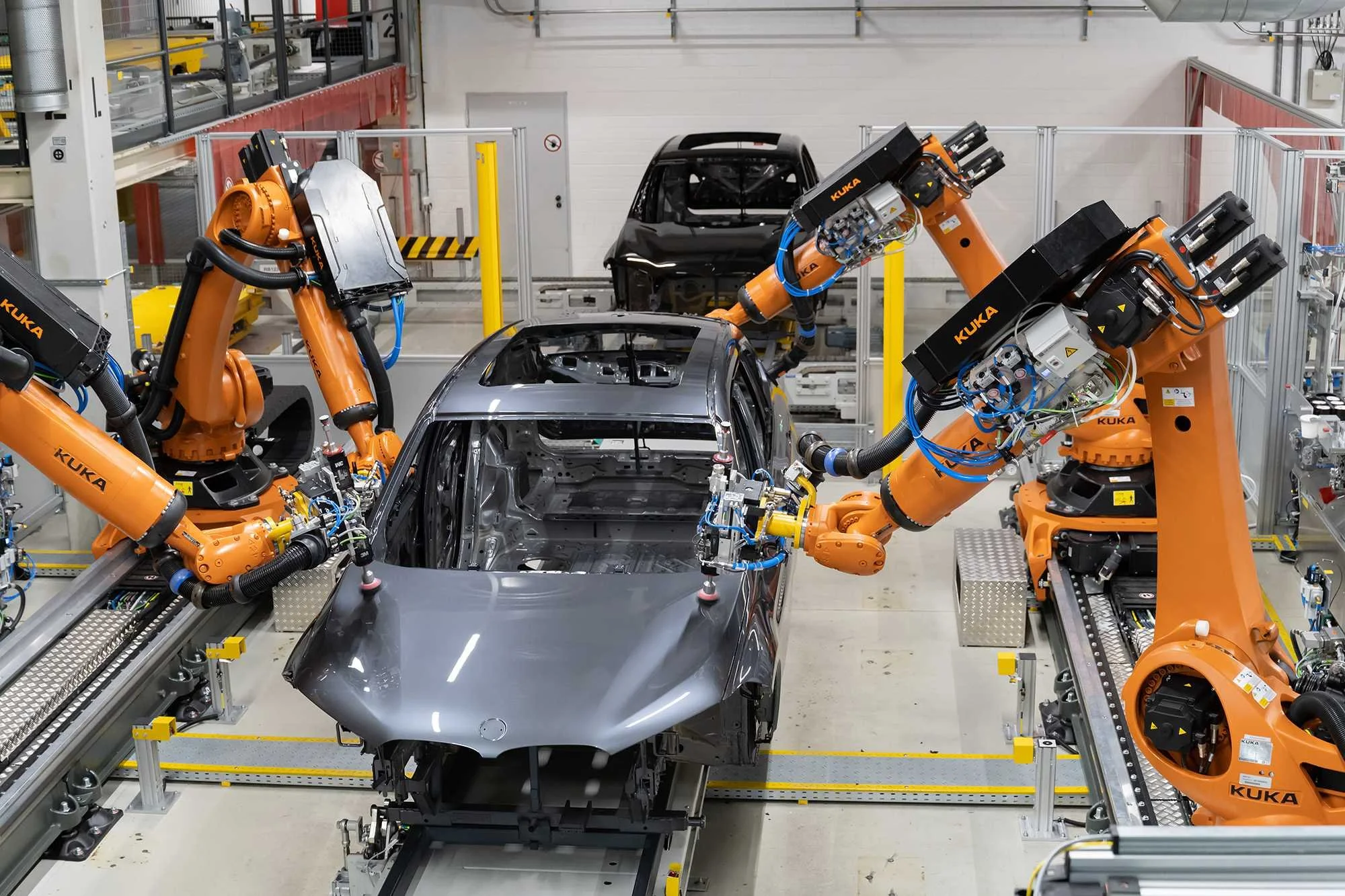 Robots assembling a car in an automotive manufacturing plant.