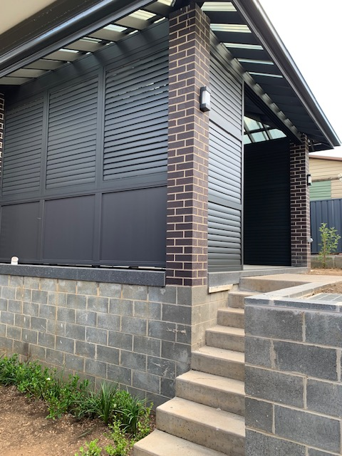 Sliding & Fixed Outdoor Shutters in Monument Colour with No Visible Tilt Bars. (Outside View)