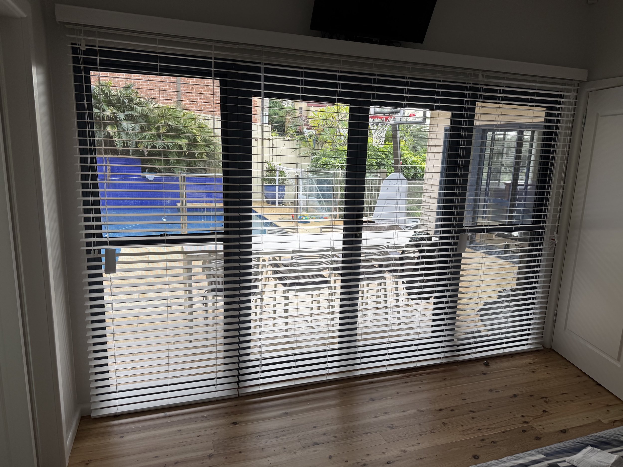 PVC Venetian blinds fully open allowing maximum natural light into a Narellan home.