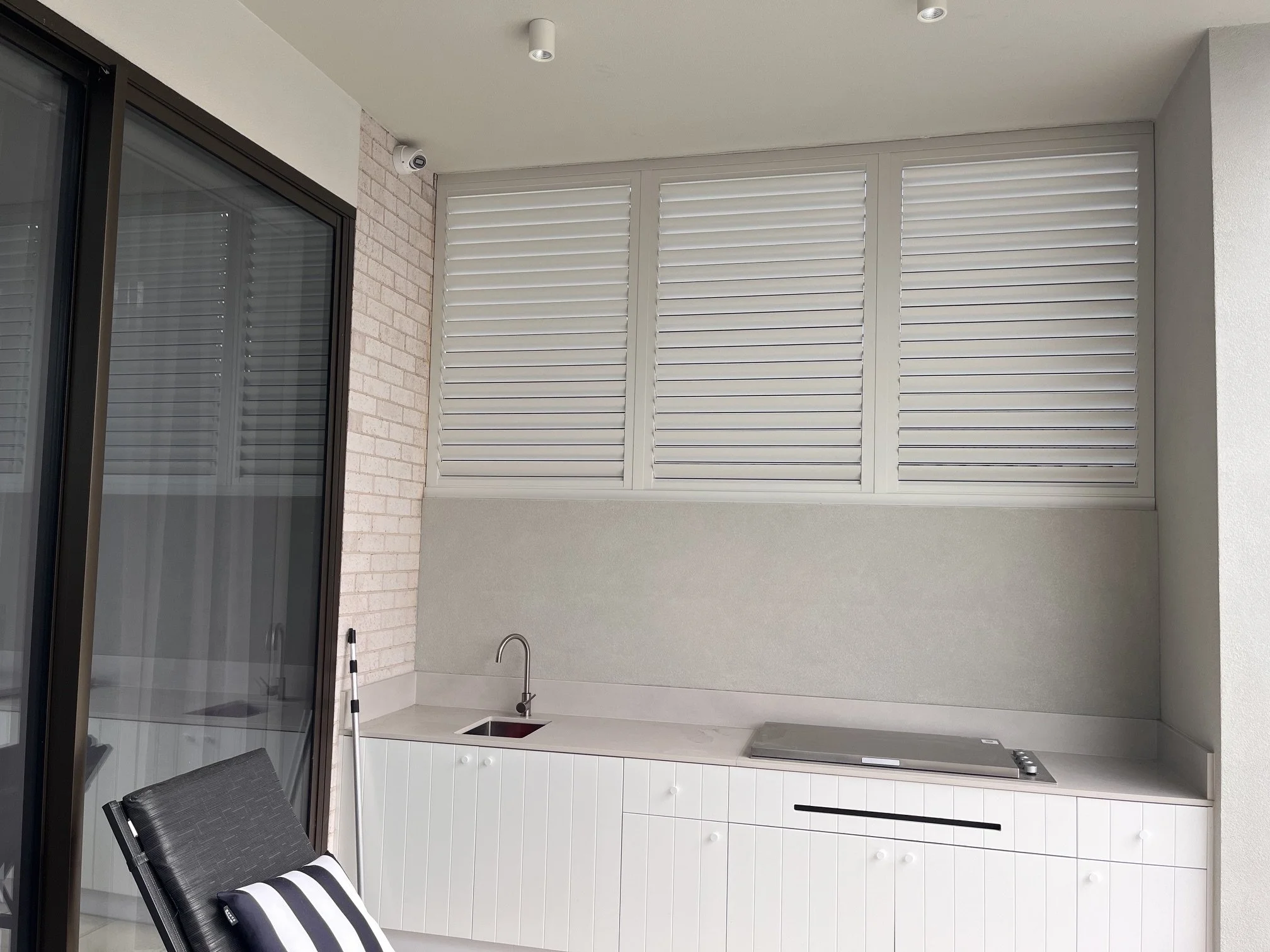 Outdoor aluminium shutters with adjustable louvres closed for privacy in Wilton