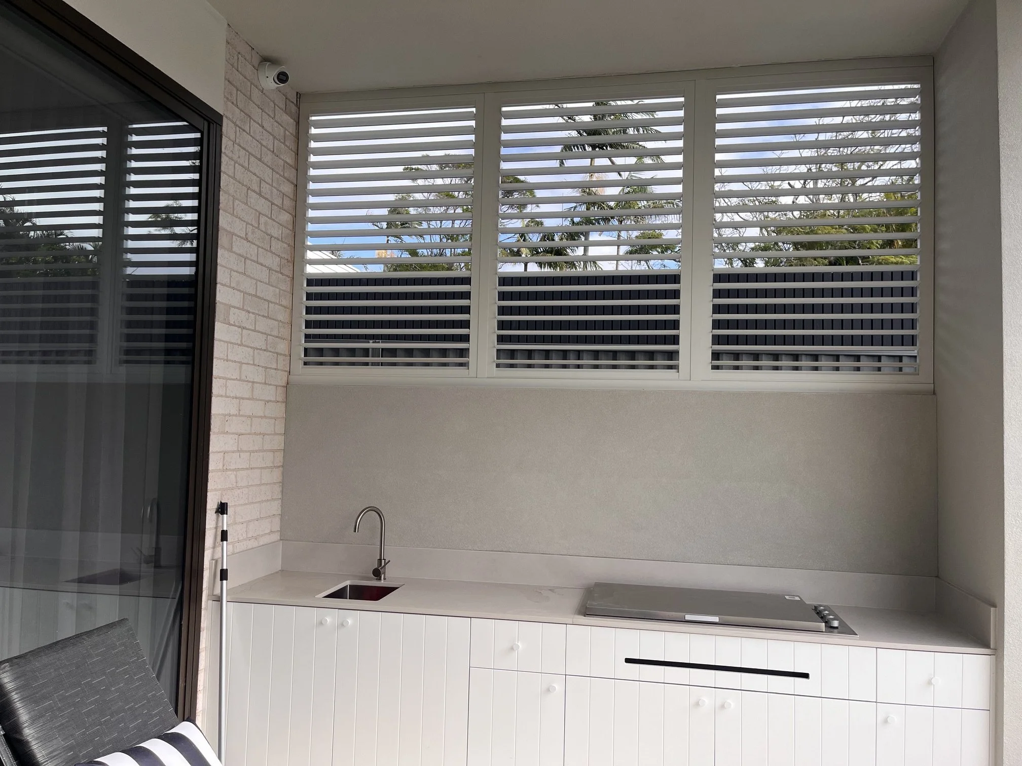 Slimline Series outdoor shutters with adjustable louvres open to allow airflow and light in Wilton NSW.