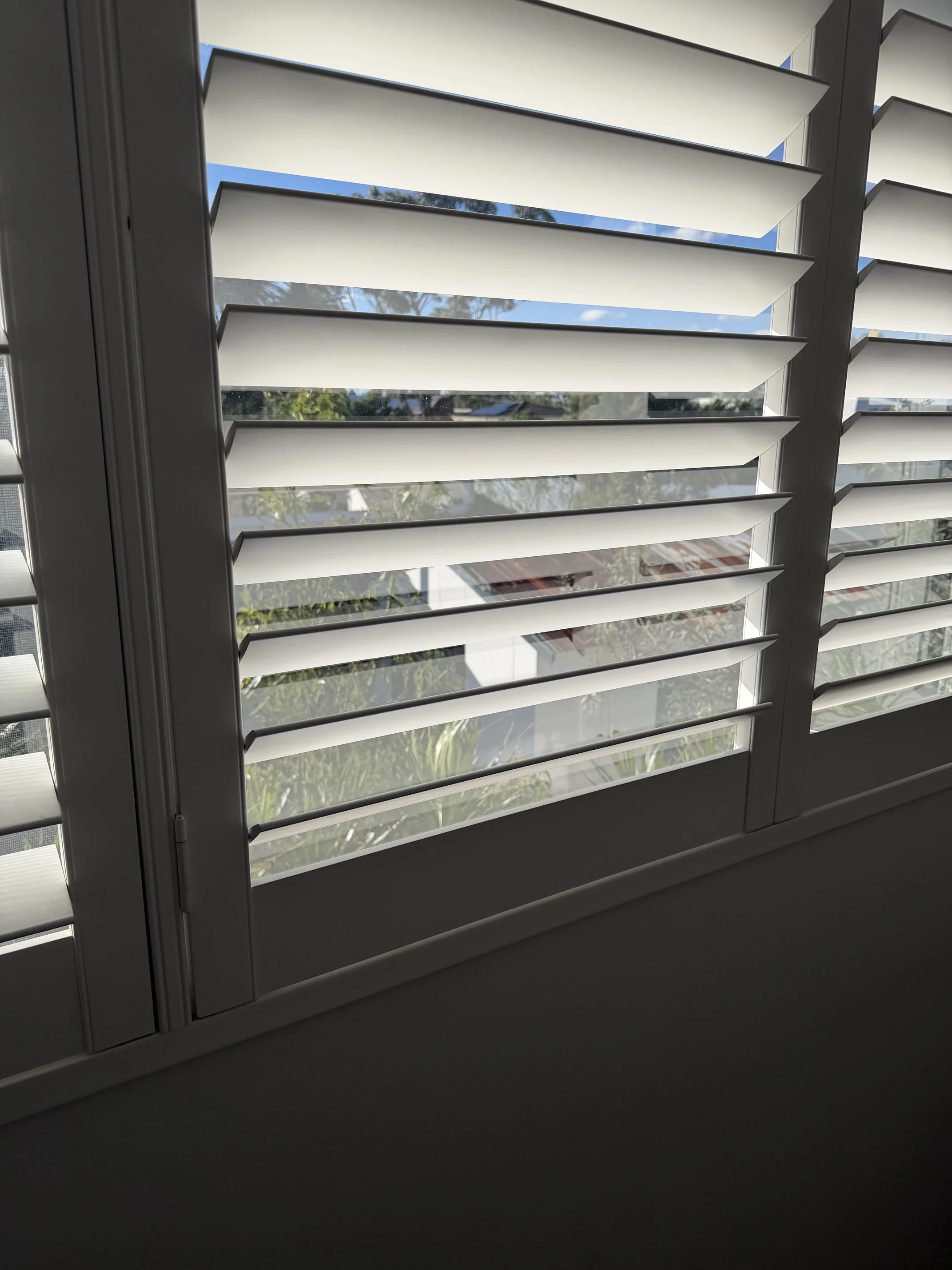 Repaired plantation shutter with open louvres in Narellan NSW