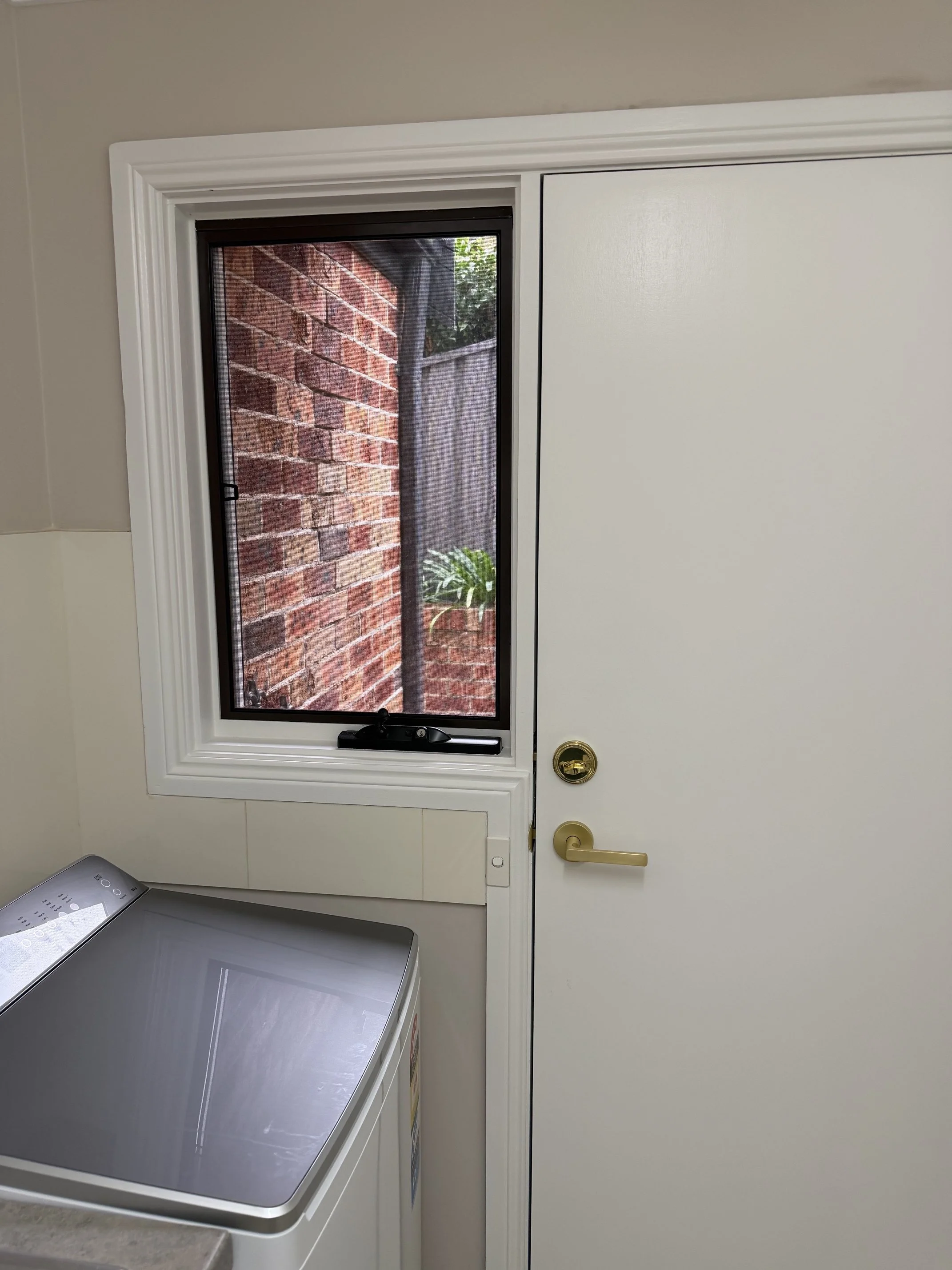 Laundry window before window furnishing installation in Ingleburn.