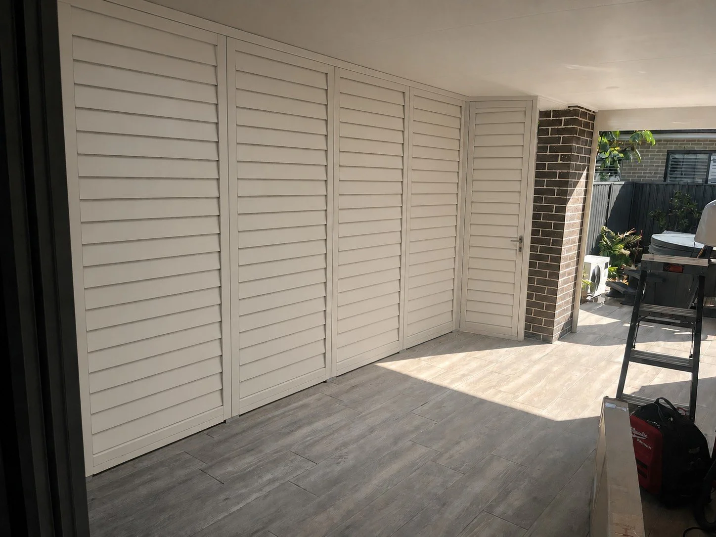 AI design preview showing proposed sliding and hinged outdoor aluminium shutters for an Elderslie entertaining area.