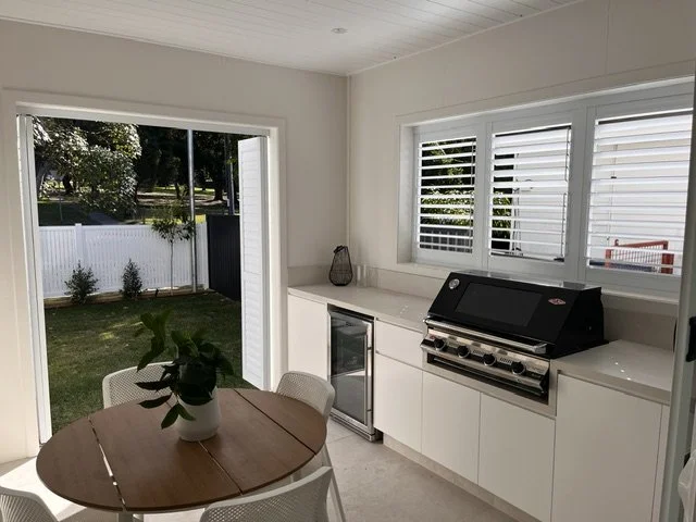 Indoor view of bifold outdoor shutters open in a Picton entertaining area