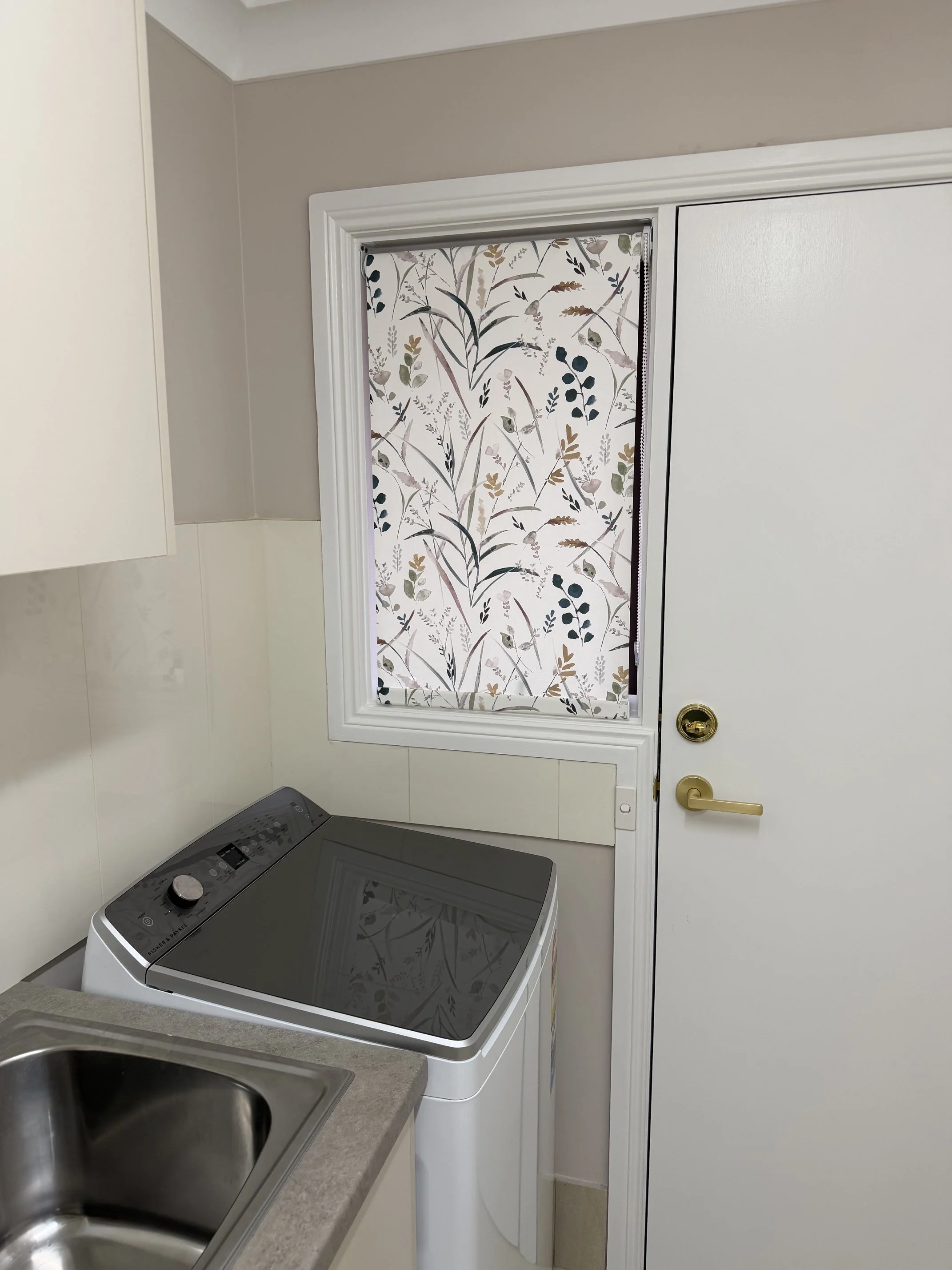 Pattern fabric roller blind installed in a laundry room in Ingleburn