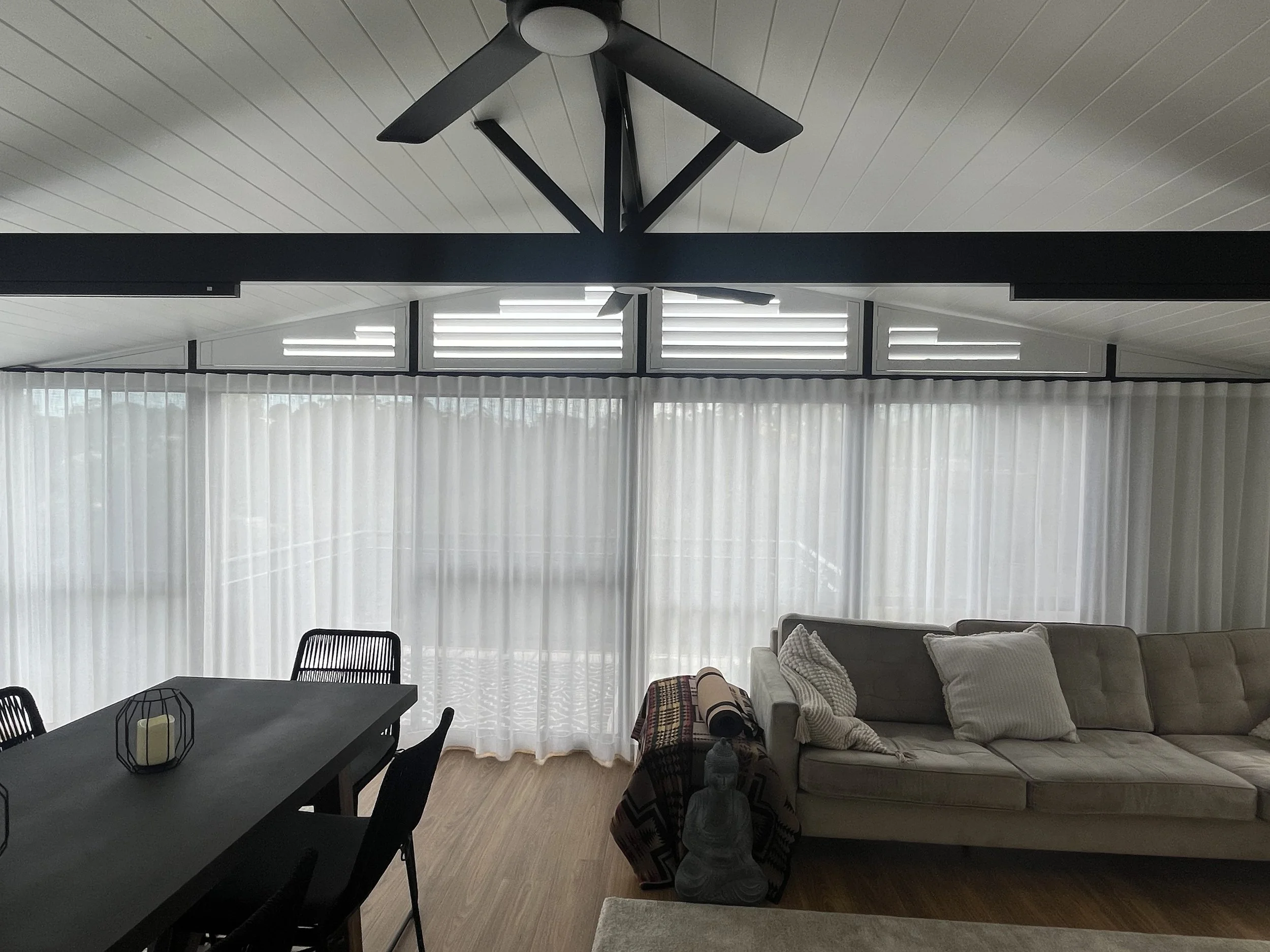 Sheer curtains installed in a Camden living room providing privacy and natural light