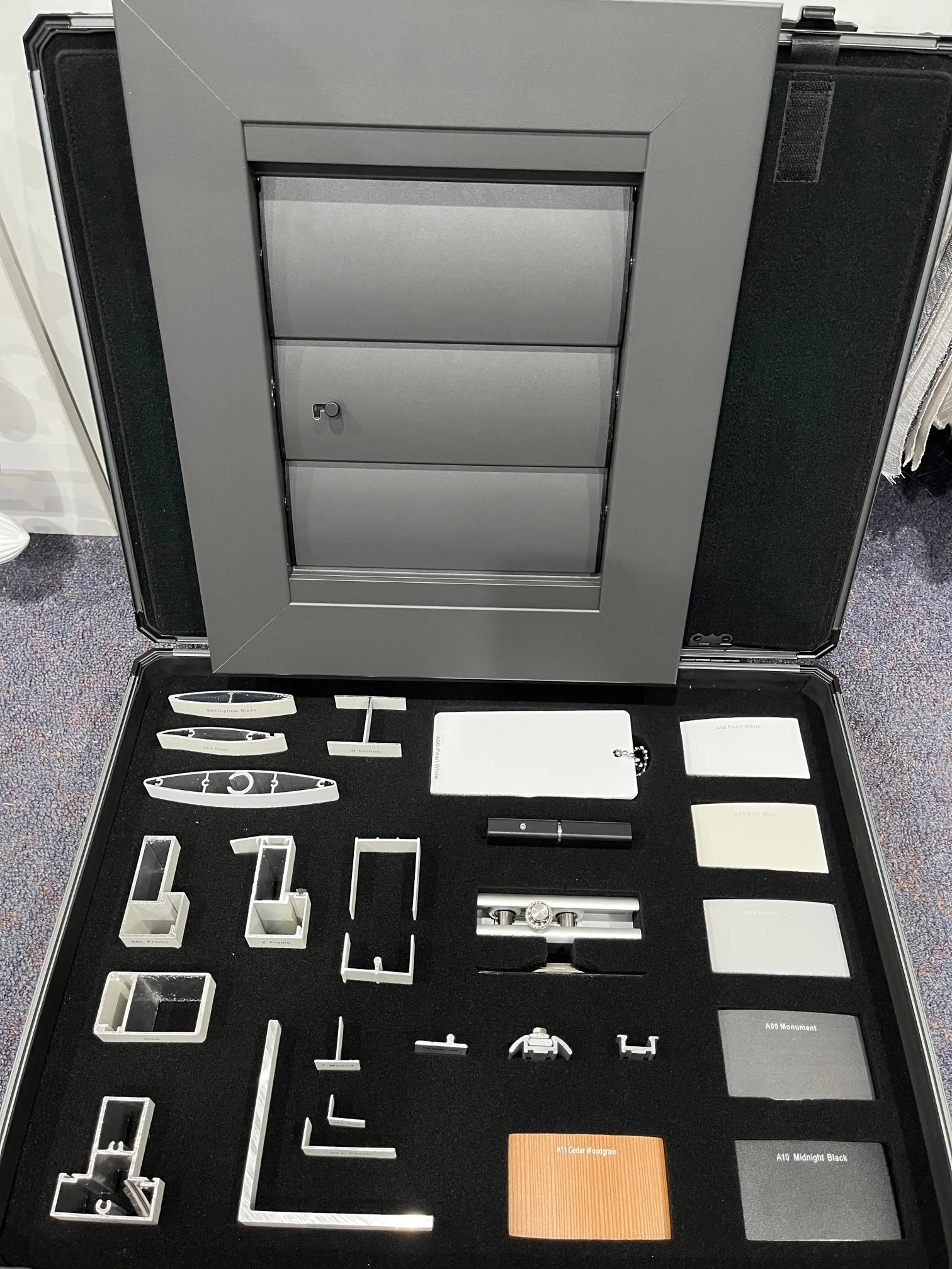 Slimline aluminium shutter frame and component sample showing concealed operating system and hardware.