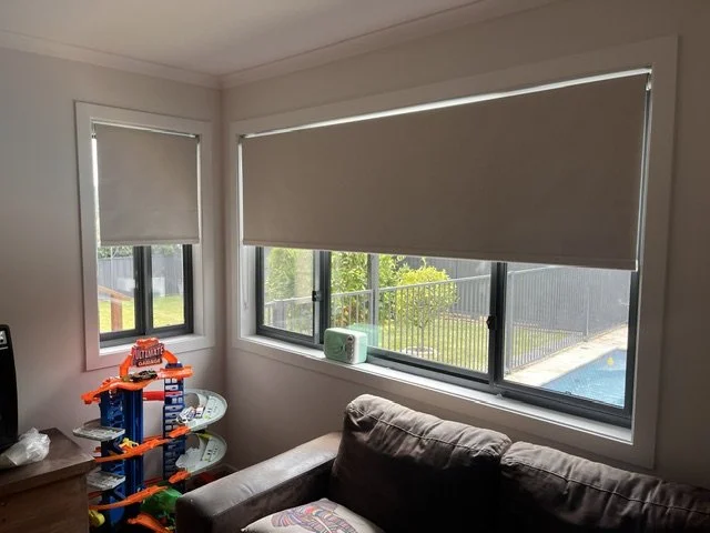 Completed roller blinds installation in a Camden living room overlooking the outdoor area