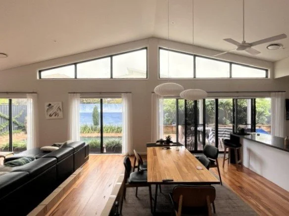 Living room in Oran Park with large shaped highlight windows before plantation shutter installation