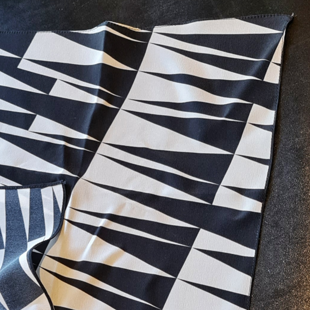 Roman sculpture style candle inside a glass container