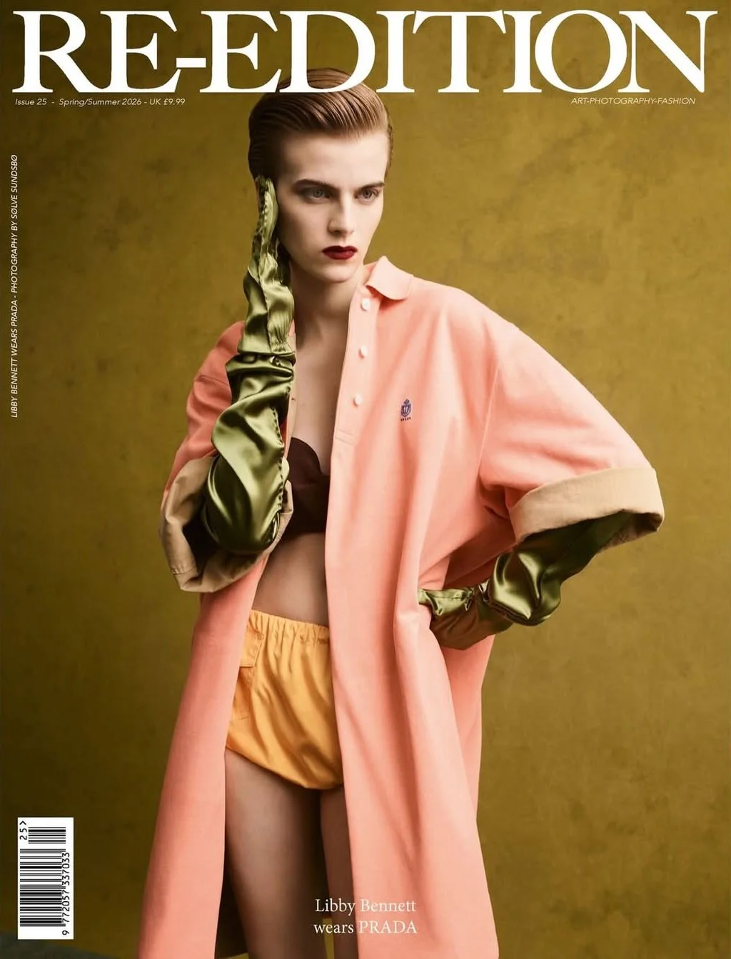 Fashion magazine cover featuring a model in a pink coat, olive green satin gloves, and yellow shorts against a yellow background.