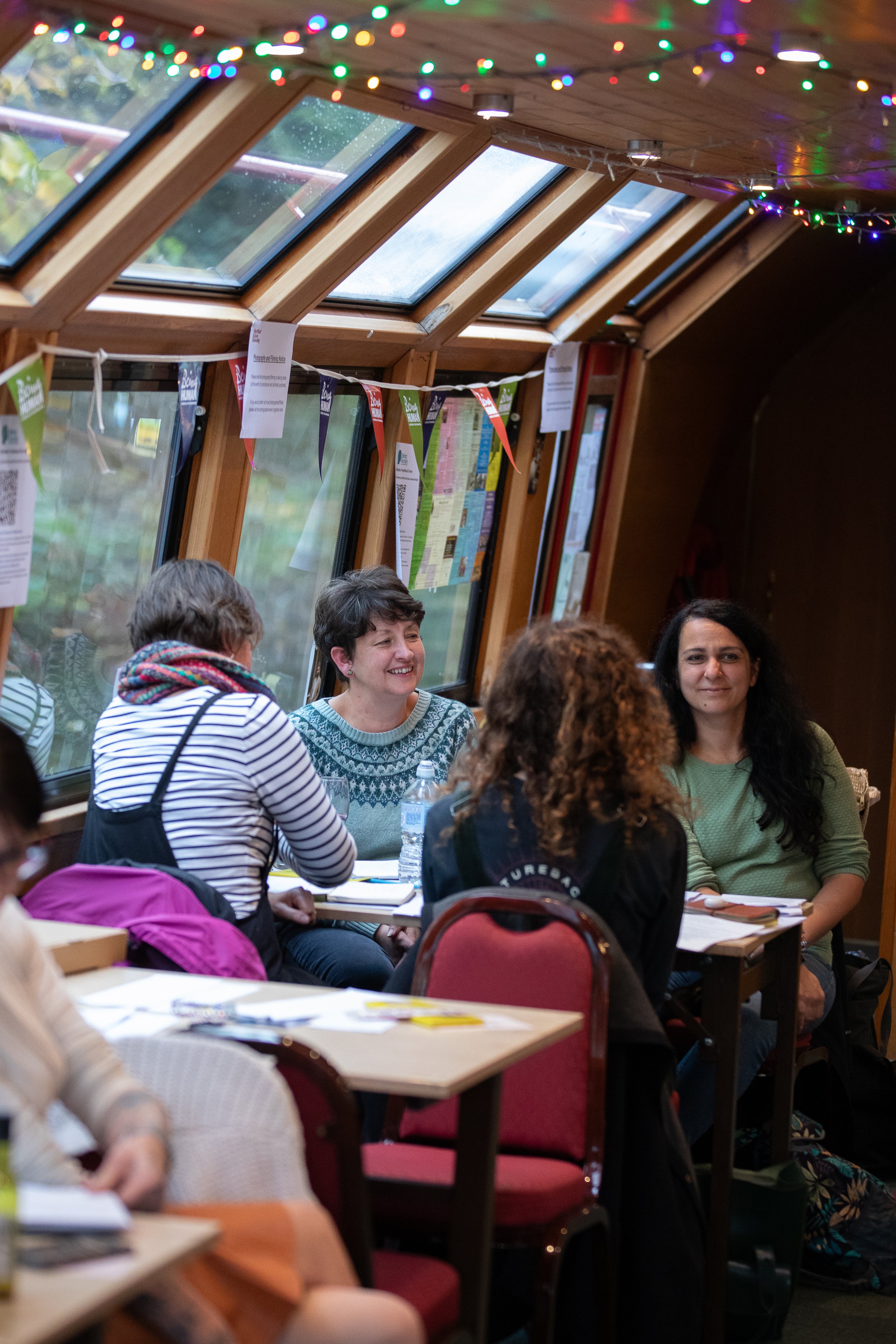 A group of people smiling, in conversation