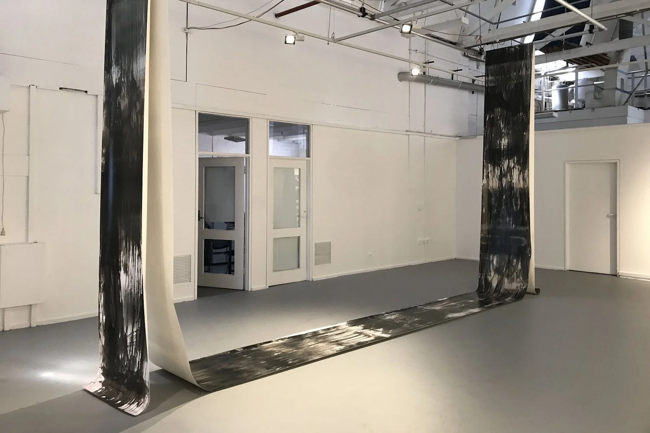 Zo Damage, 2023. Truth, gelatin silver print (continuous roll), 16 metres x 70 cm overall. Installation variable. Installation view, RMIT University, 2023