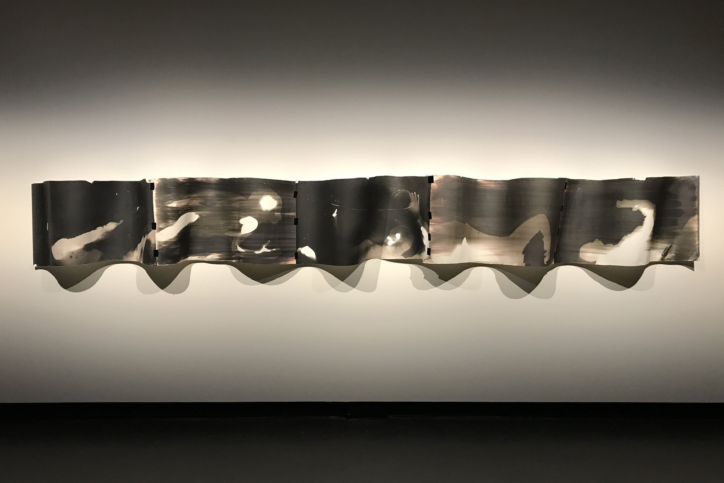Zo Damage, 2022. Wave Wall, photograms (gelatin silver prints, gaffer tape, 7 metres x  60 cm overall. Installation variable. Installation view, RMIT University, 2022
