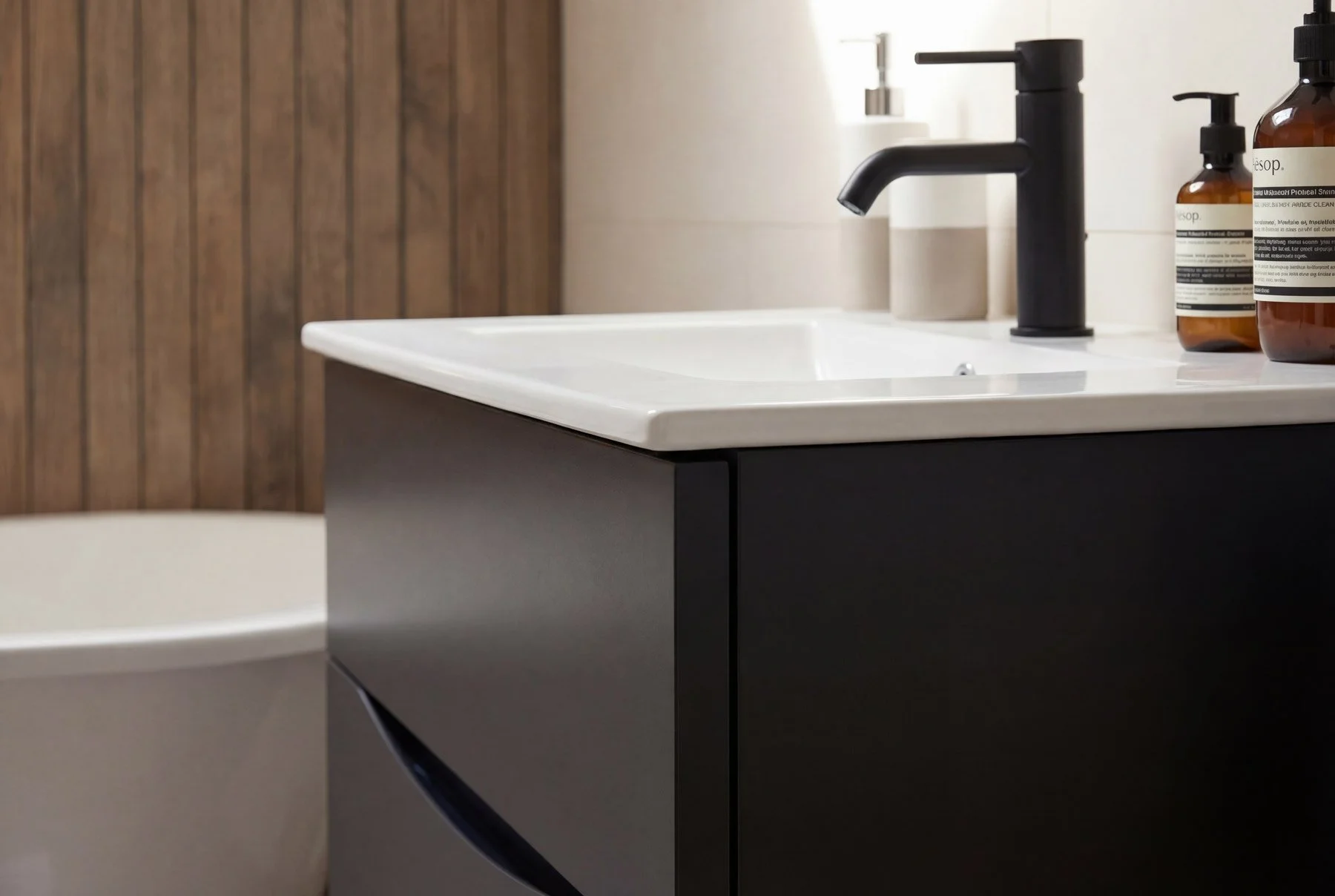 modern-bathroom-roll-top-bath-dark-vanity-unit-close-up.jpg