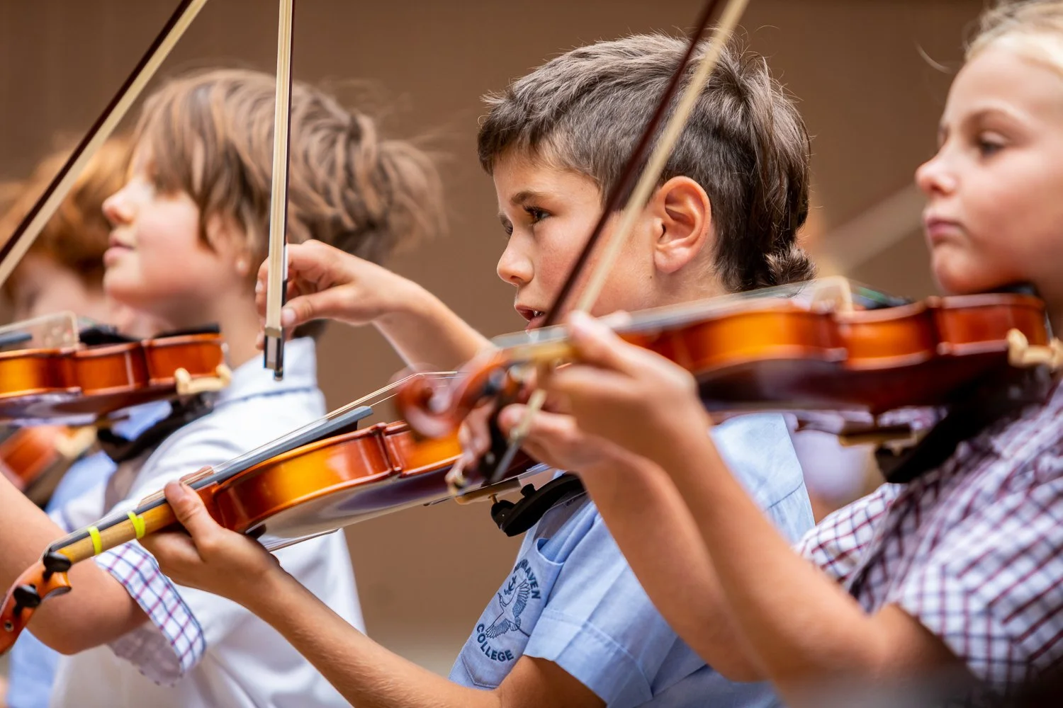 Young children playing violins during a music class or rehearsal. school photography and advertising photography, content creation and video by Jess Grant and Alys Carr, Melbourne Australia.
