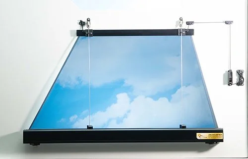 A SkyCeiling panel with a sky and cloud scene, mounted on a white wall with mechanical attachments and a control box.
