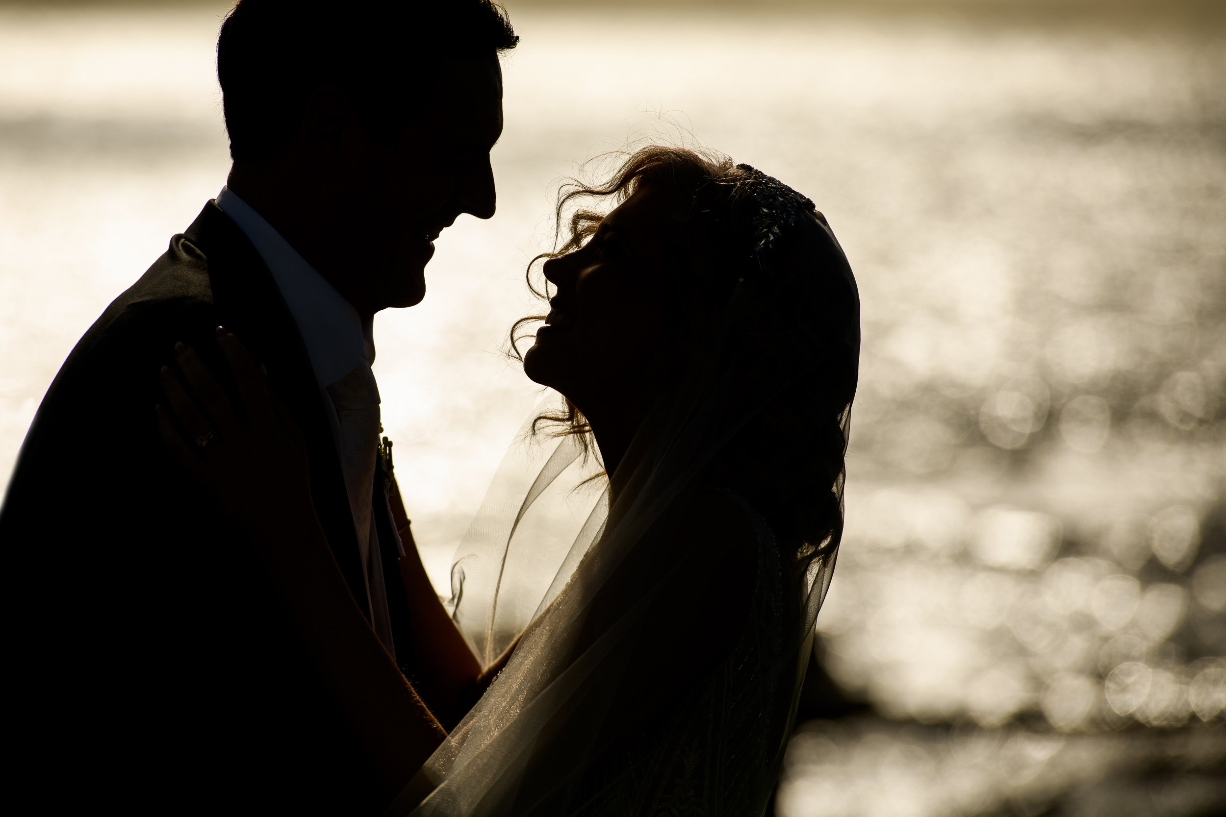 Bride and groom embracing during a romantic wedding portrait with cinematic lighting in Ireland