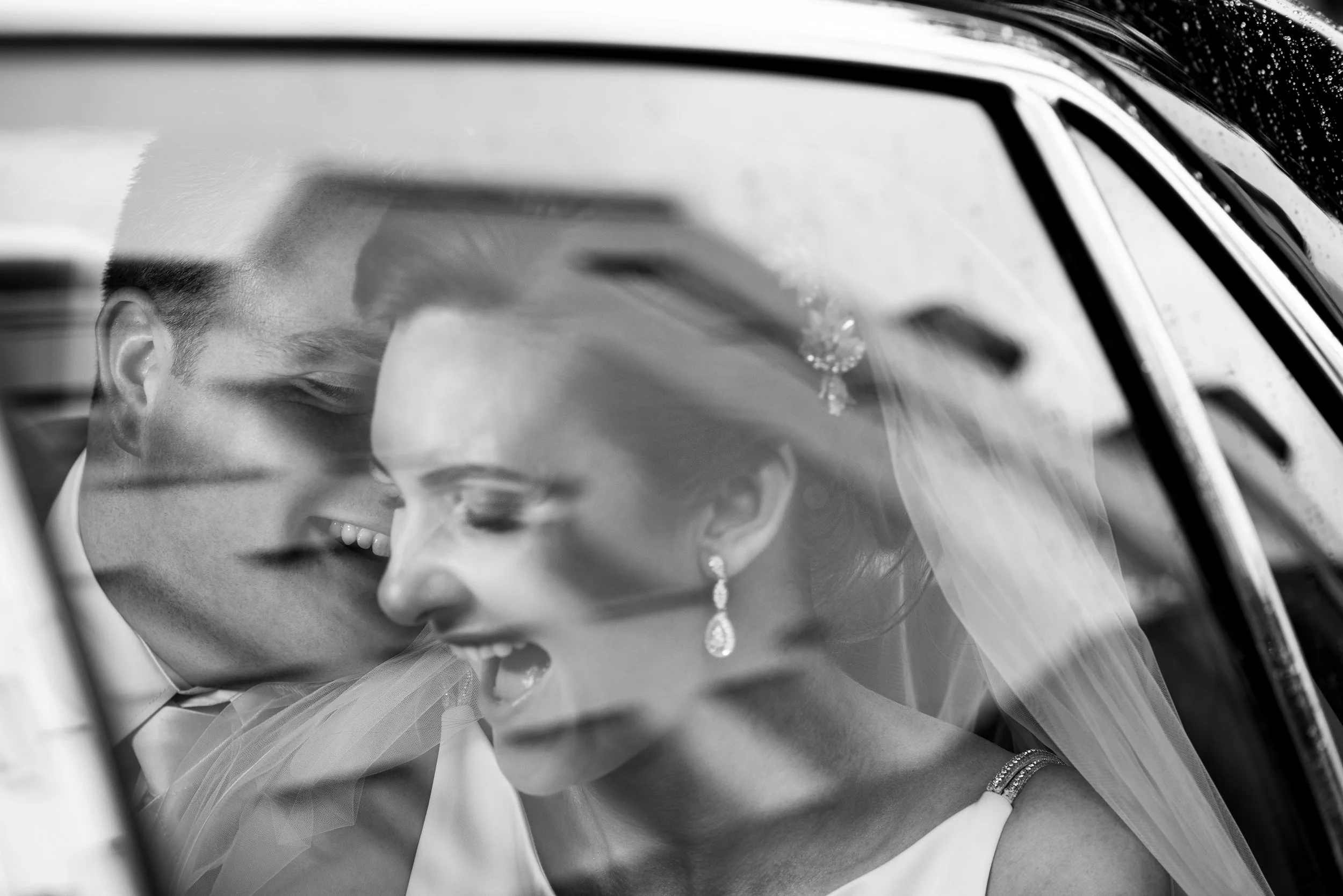 Wedding Photography Galway – bride and groom laughing in car at Salthill Hotel