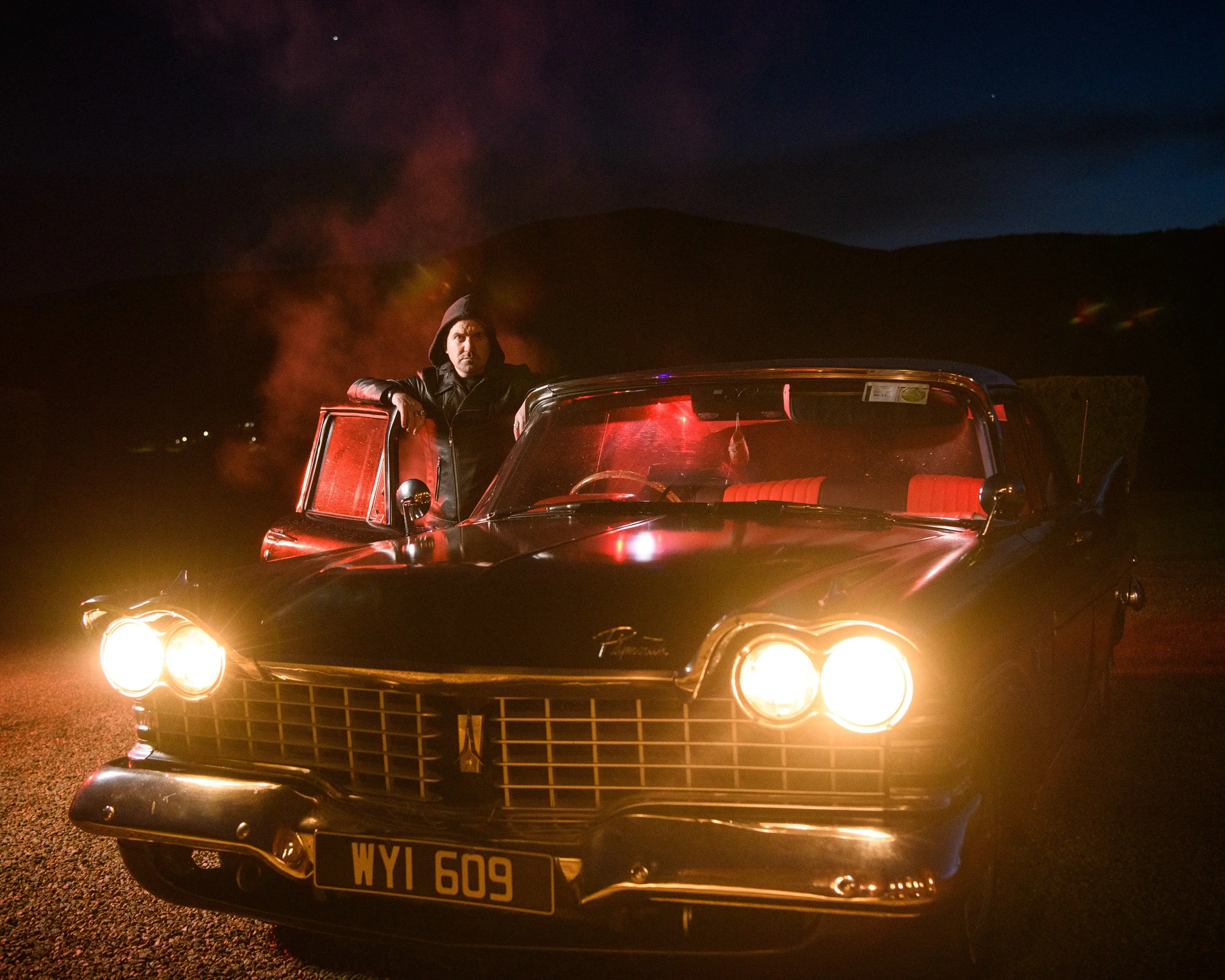 Editorial Portrait Photography Ireland – night portrait with car headlights at Castle Oliver