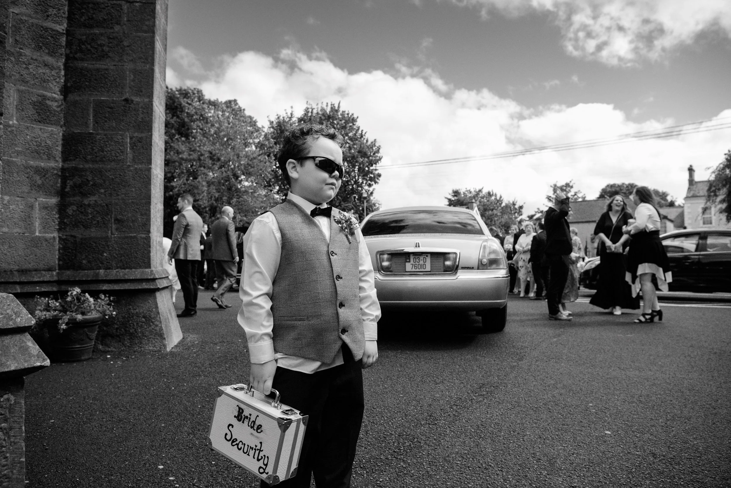 Wedding Photography Ireland – page boy “Bride Security” moment outside church
