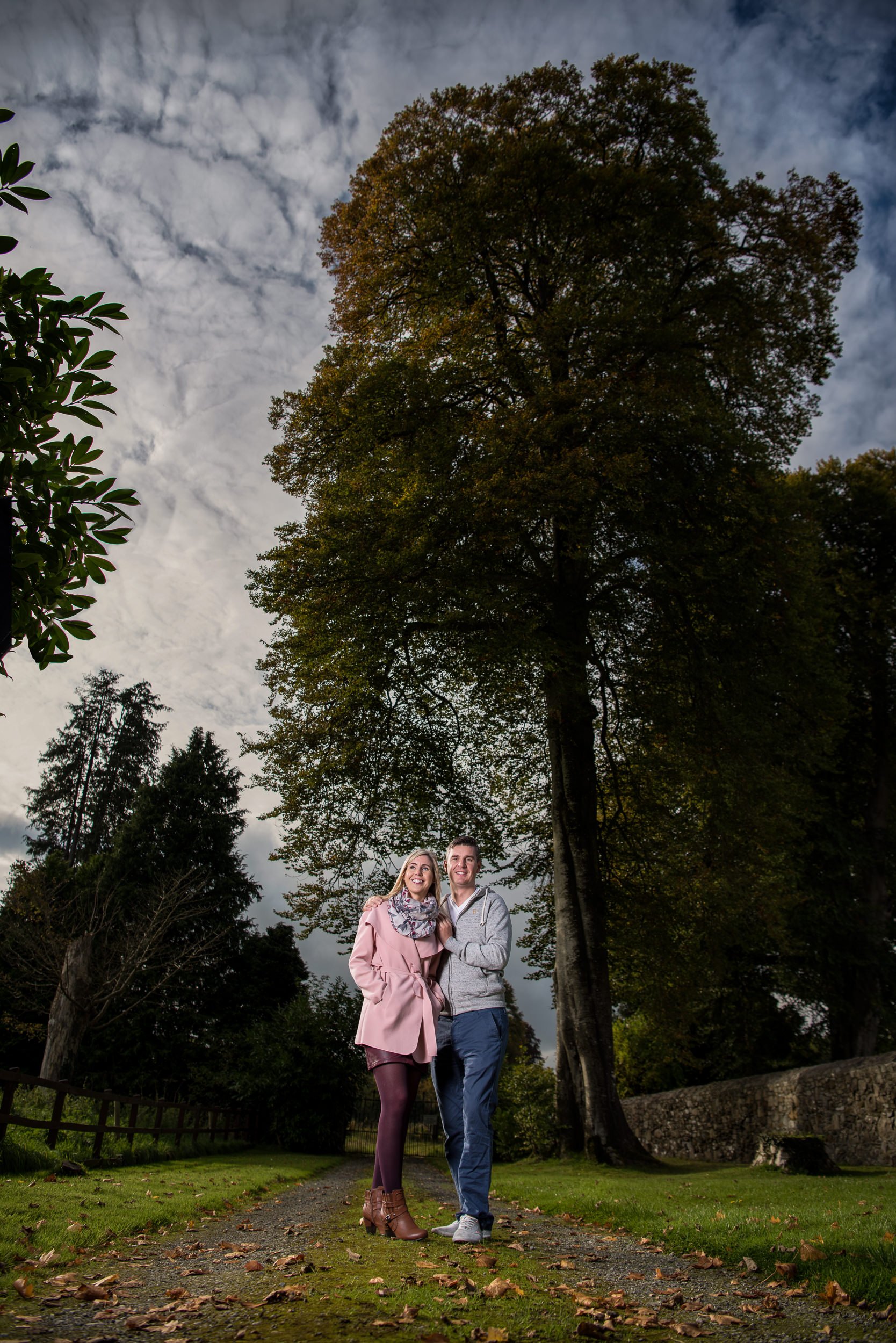 Engagement Photography Laois – couple walking tree-lined path in Durrow