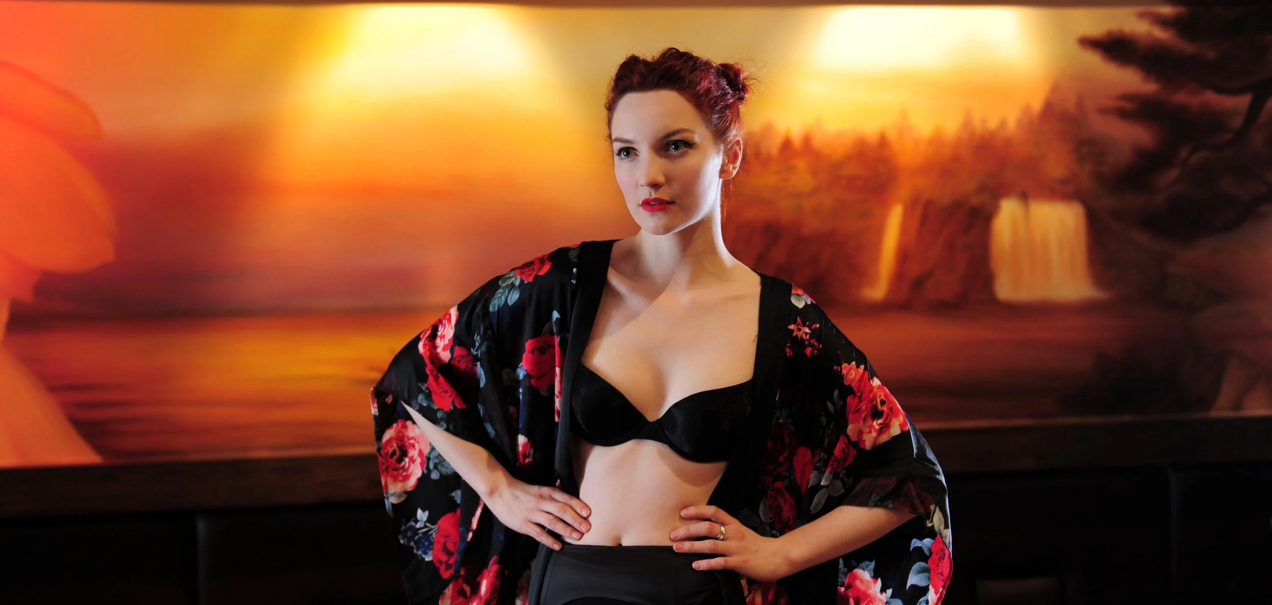 Creative portrait of a woman in a floral kimono against a dramatic landscape backdrop