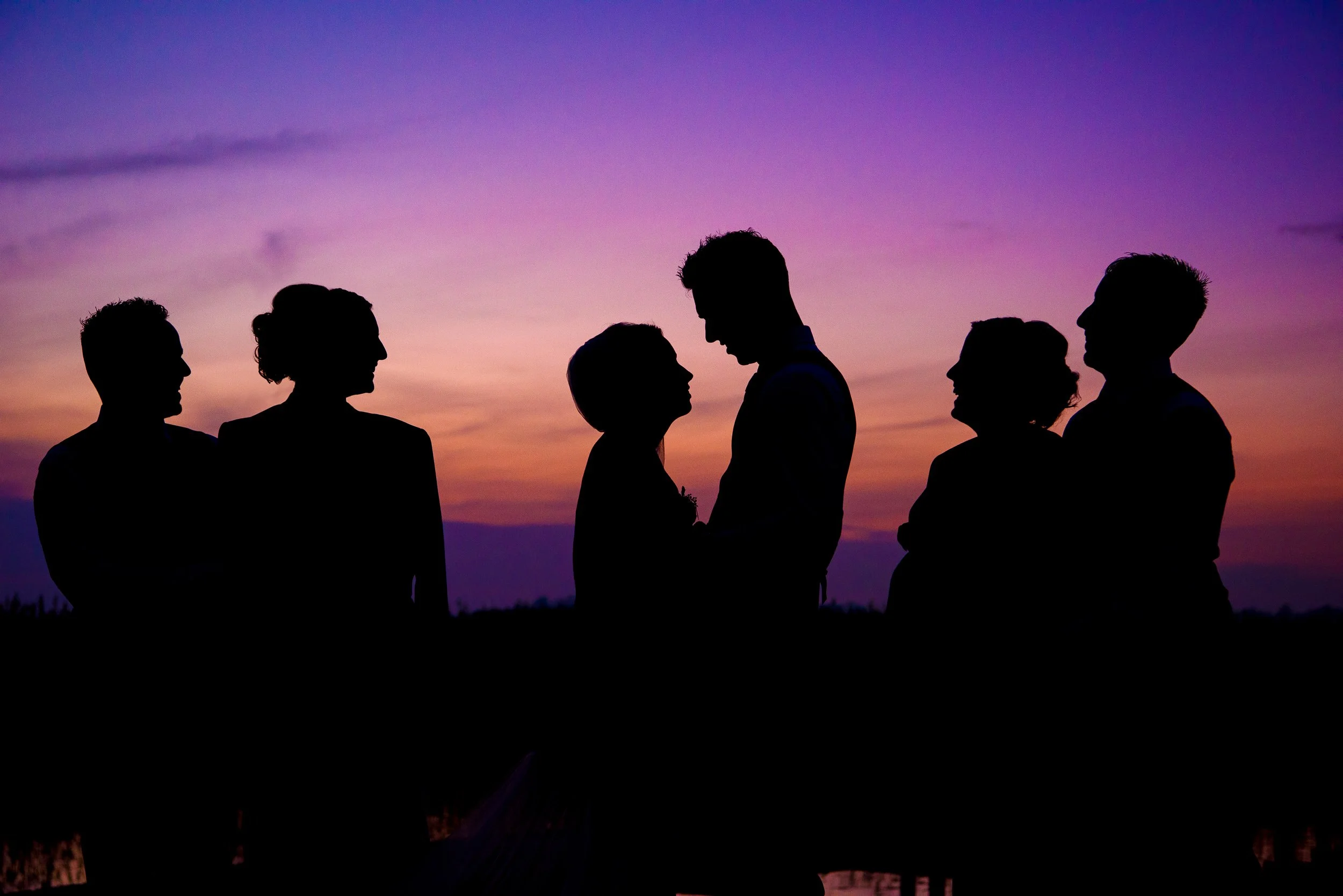 Family Photography Ireland – group silhouette at sunset with colourful sky at The Bloomfield House Hotel 