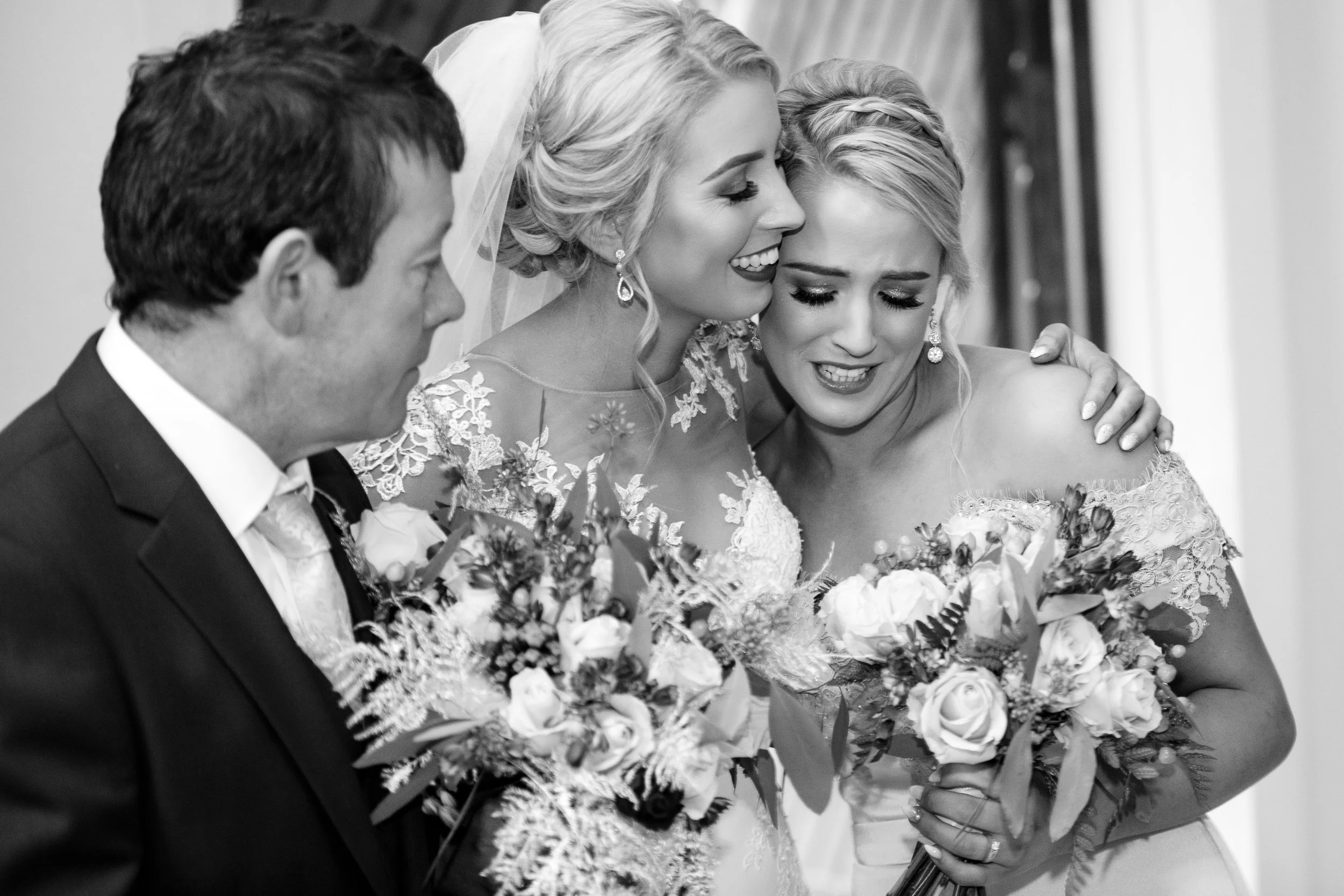 Wedding Photography Westmeath – emotional bride and bridesmaid embrace at Castletown Geoghegan Church