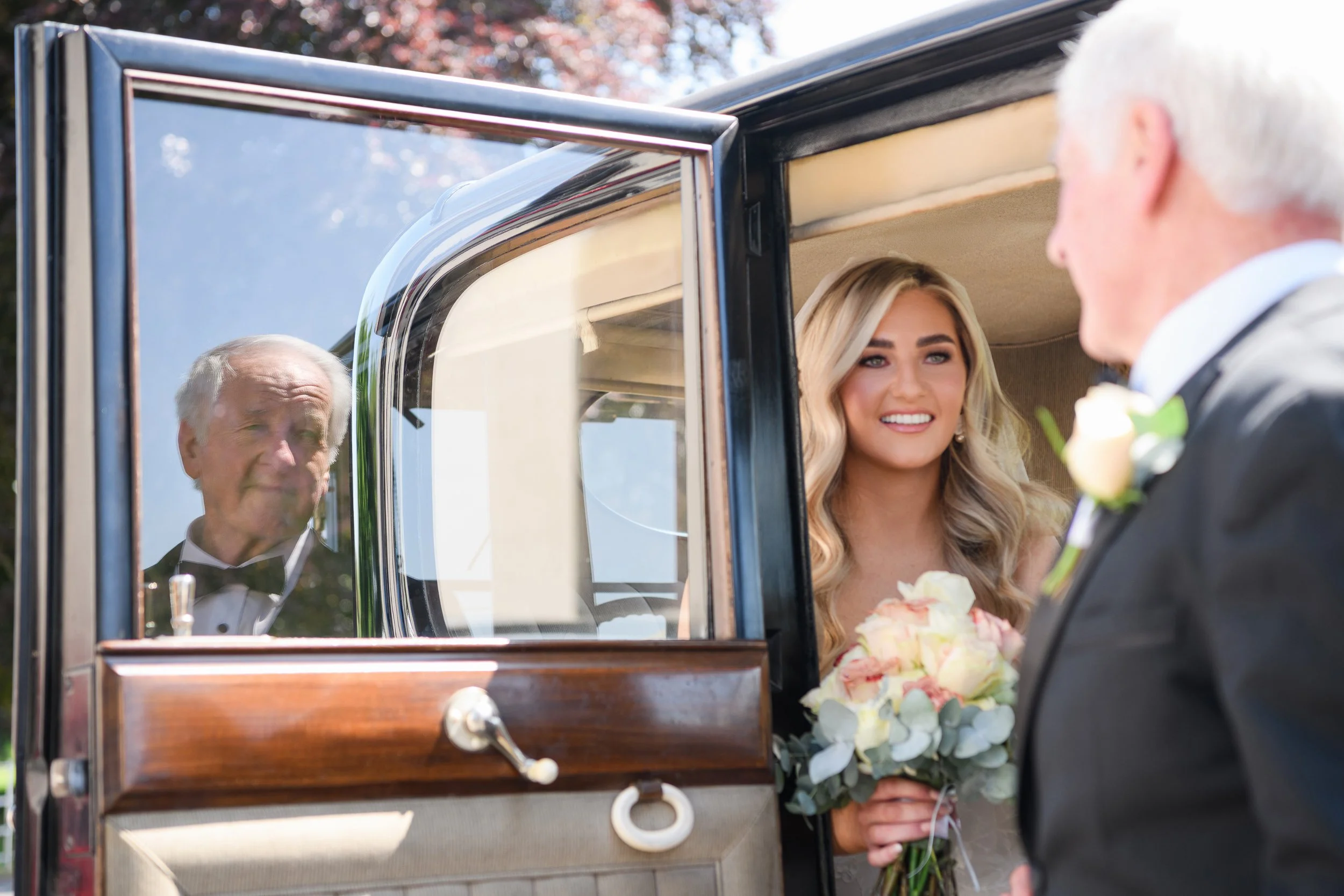 Wedding Photography Westmeath – bride arriving at ceremony with reflection in car window at Glasson Lakehouse