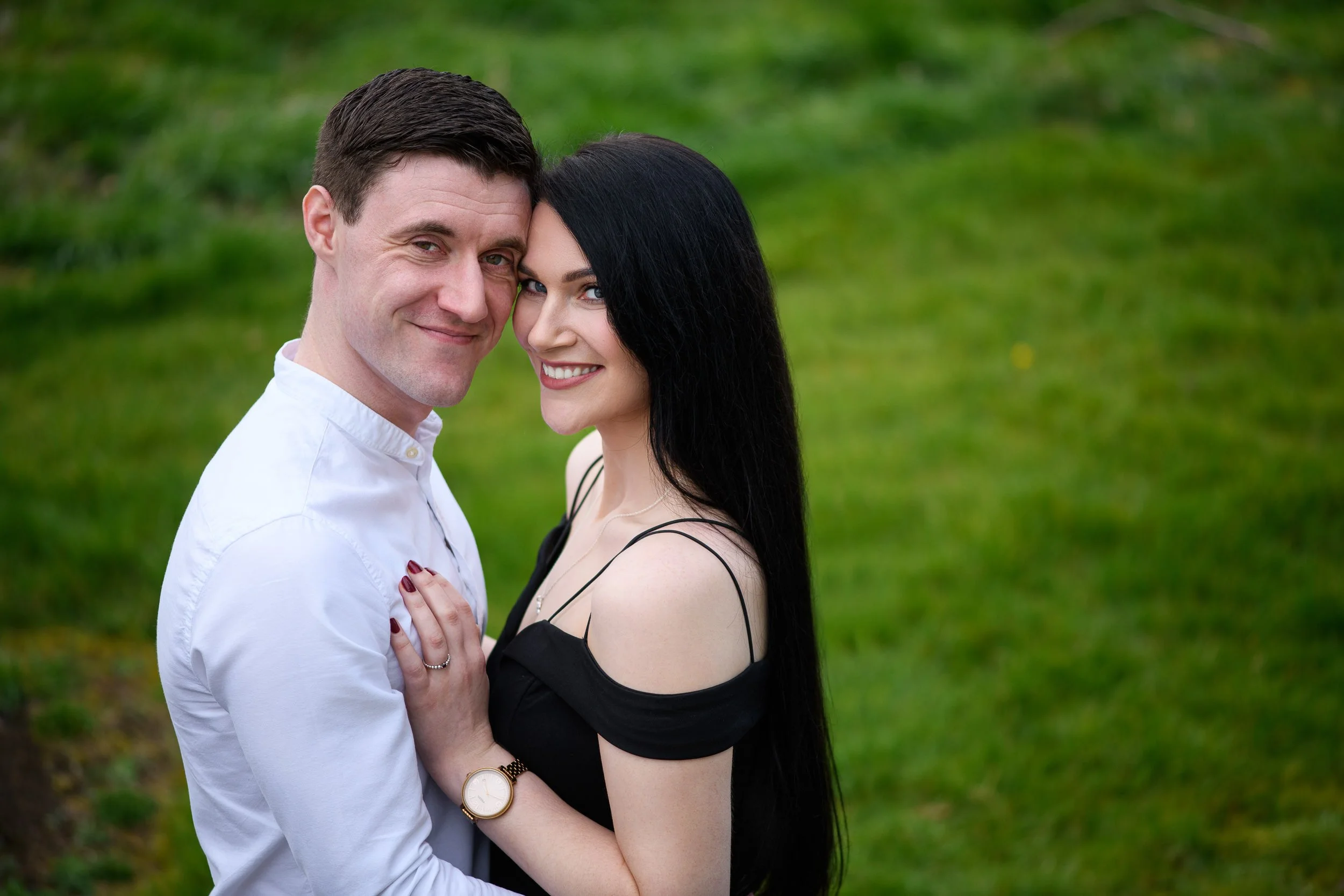 Engagement Photography Ireland – couple embracing outdoors on green lawn