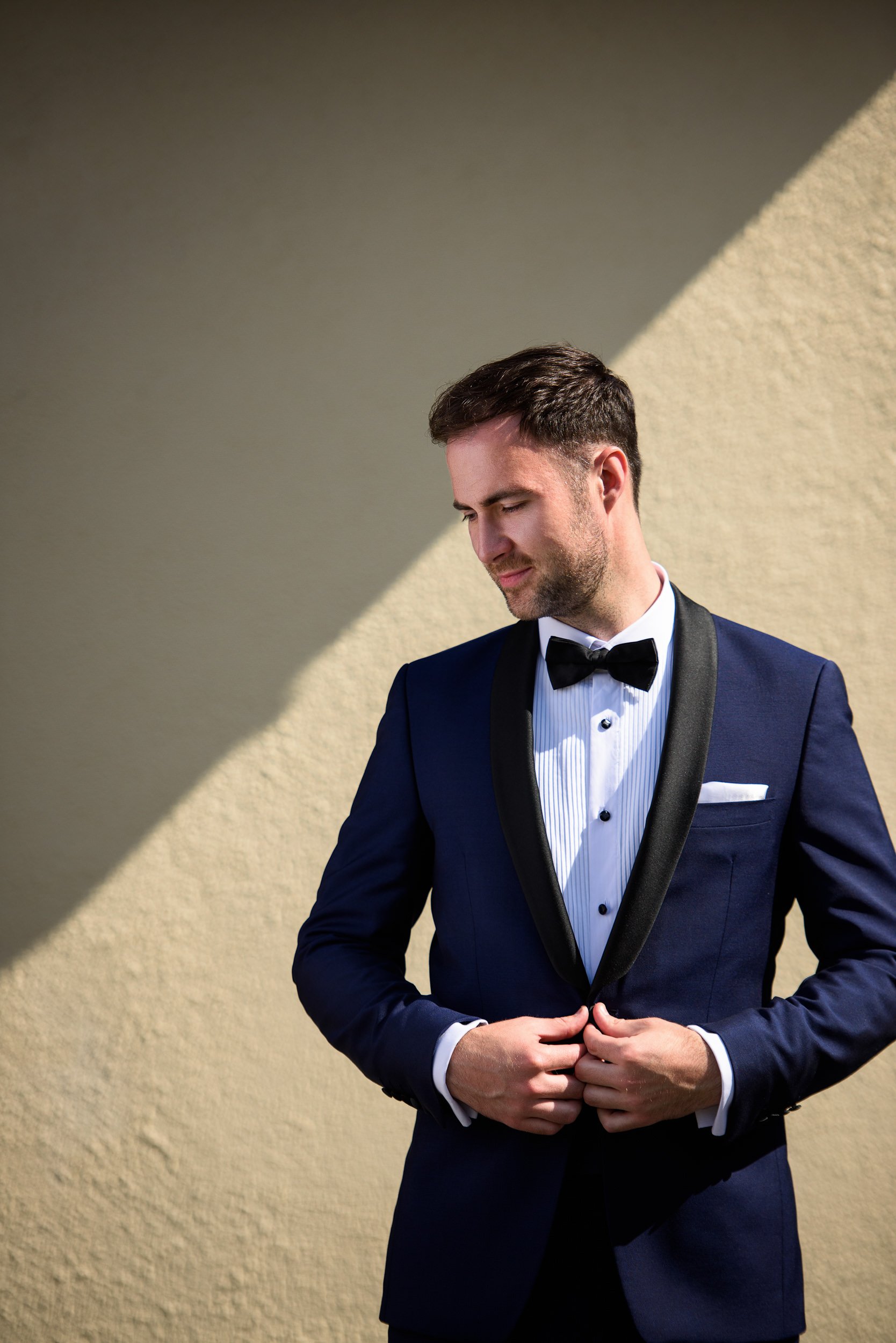 Wedding Photography Galway – groom portrait adjusting jacket before ceremony at The Hardiman Hotel